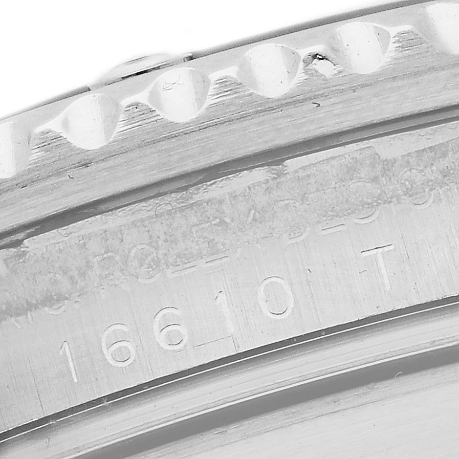 The image shows a close-up of the bezel and engraved case side of a Rolex Submariner 16610 T Men's Stainless Steel Black Dial 16610 T Men's Stainless Steel Black Dial watch.