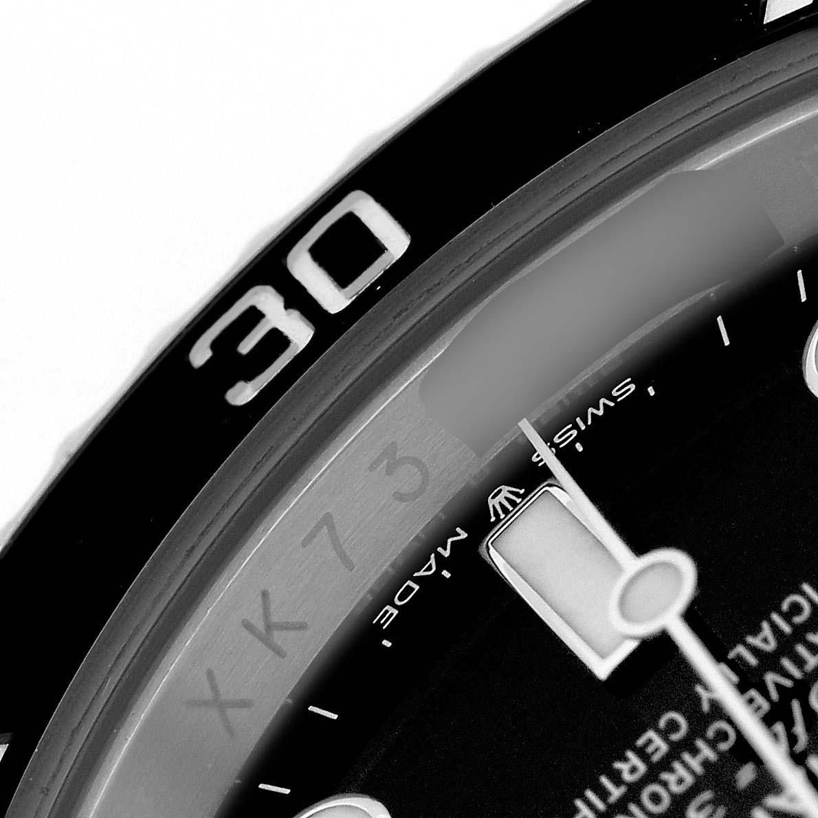 The image shows a close-up of the Rolex Submariner M124060-0001 Men's Stainless Steel Black Dial's bezel, part of the dial, and the "Swiss Made" marking.