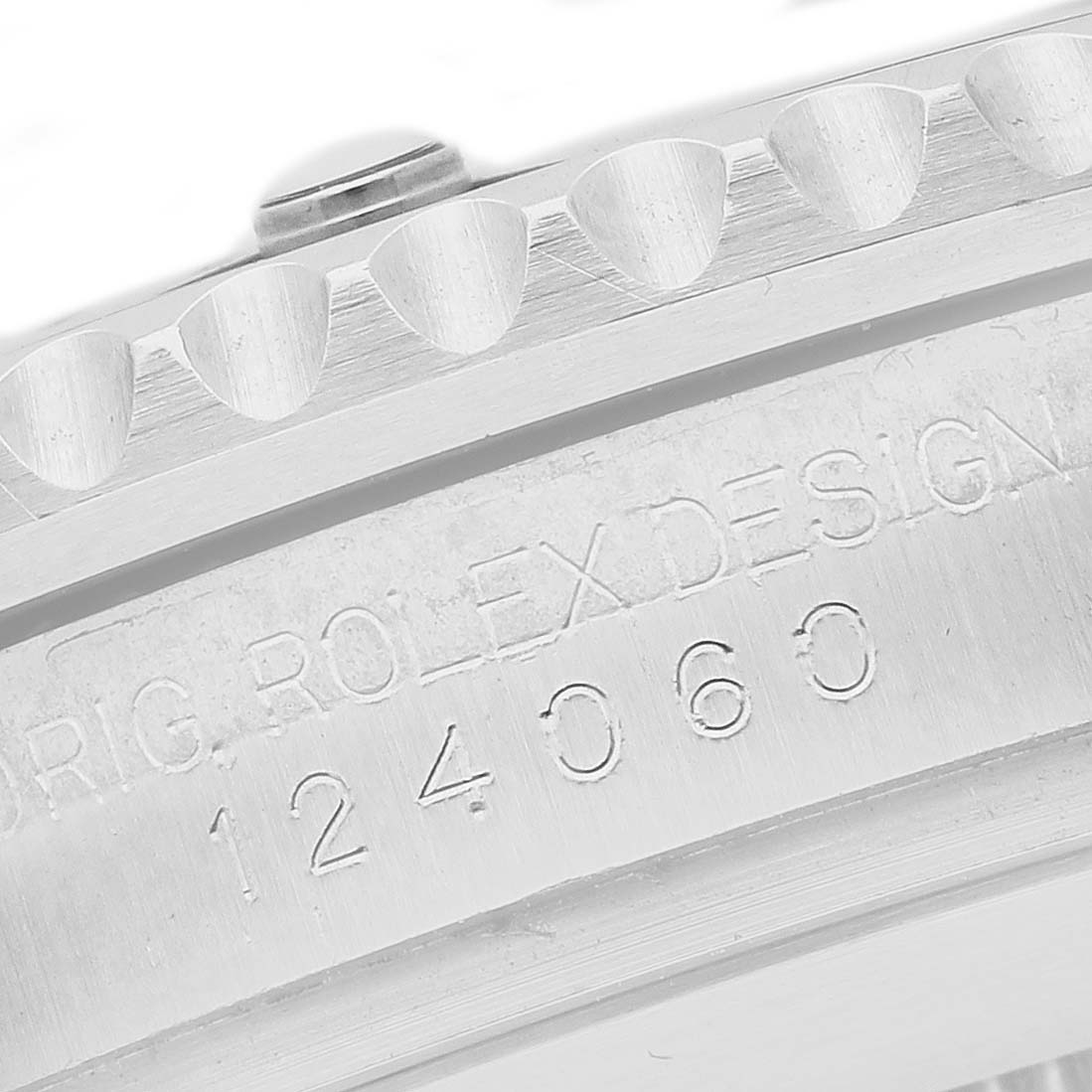 The image shows a close-up of the side case and bezel edge of a Rolex Submariner M124060-0001 Men's Stainless Steel Black Dial, highlighting the model engraving.
