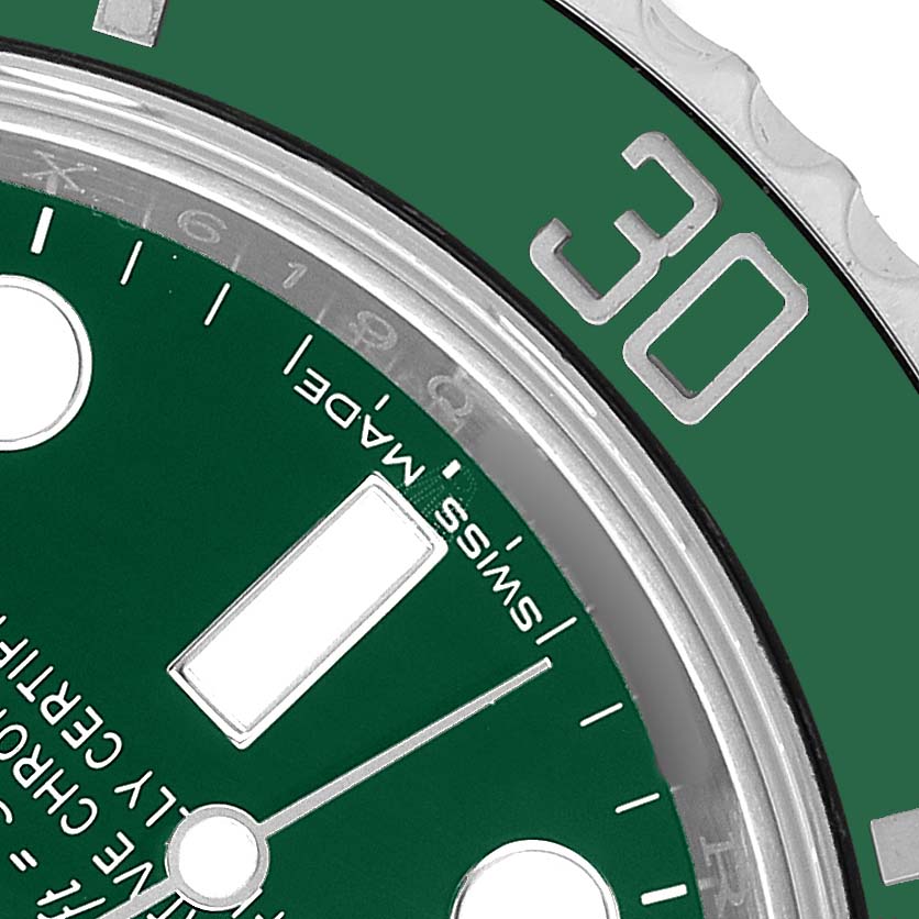 The image shows a close-up of the Rolex Submariner M116610LV-002 Men's Stainless Steel Green Dial's green dial and bezel from an angled side view highlighting the 30-minute mark.