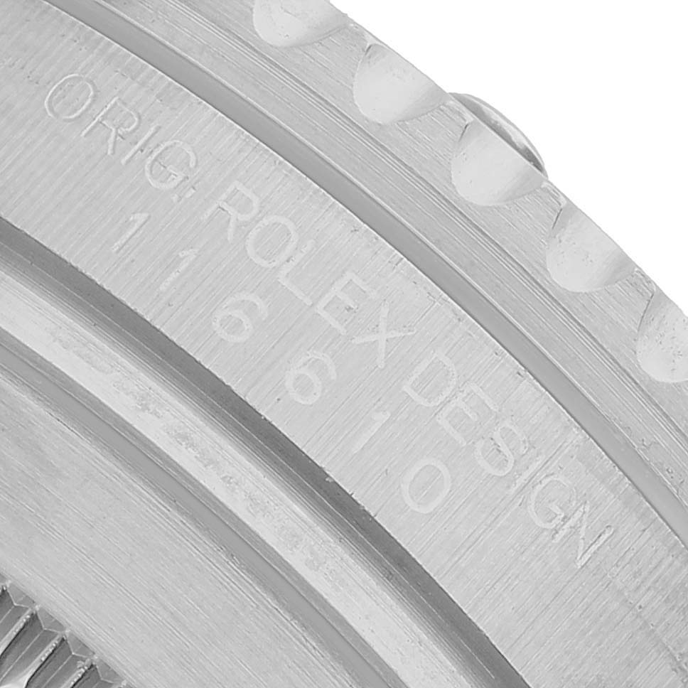 The image shows a close-up of the side of a Rolex Submariner M116610LV-002 Men's Stainless Steel Green Dial watch case, highlighting the engraved text.
