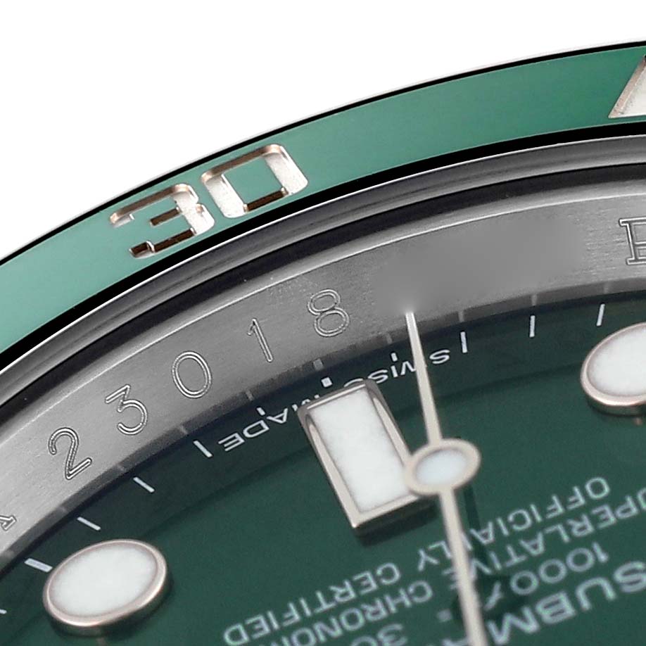 The image shows a close-up of the Rolex Submariner 116610LV Men's Stainless Steel Green Dial's dial, bezel, and part of the second hand from an angled top view.