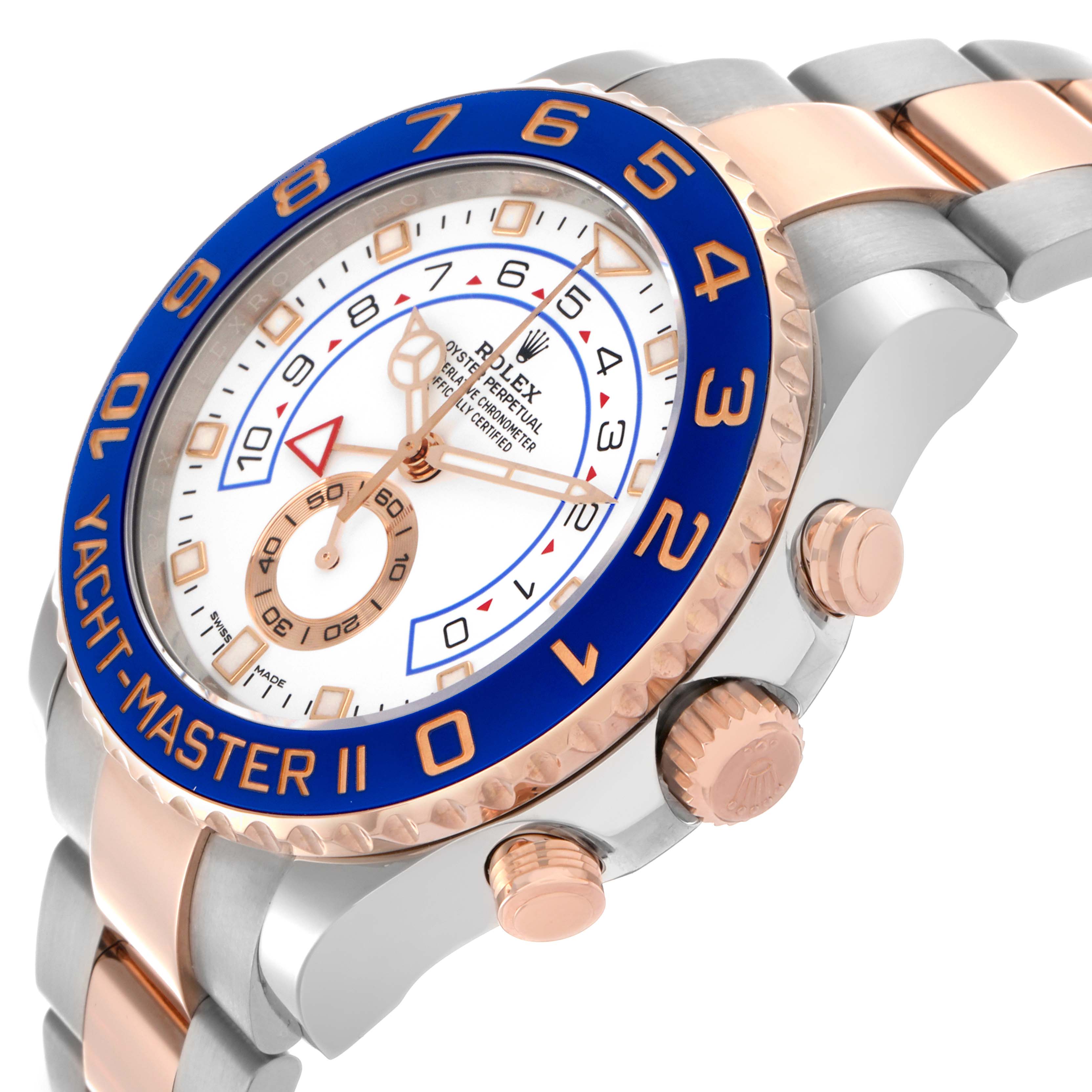 The Rolex Yacht-Master 116681 Men's Steel and Gold (two tone) White Dial 116681 Men's Steel and Gold (two tone) White Dial is shown at an angle highlighting the blue bezel, dial, side buttons, and part of the bracelet.