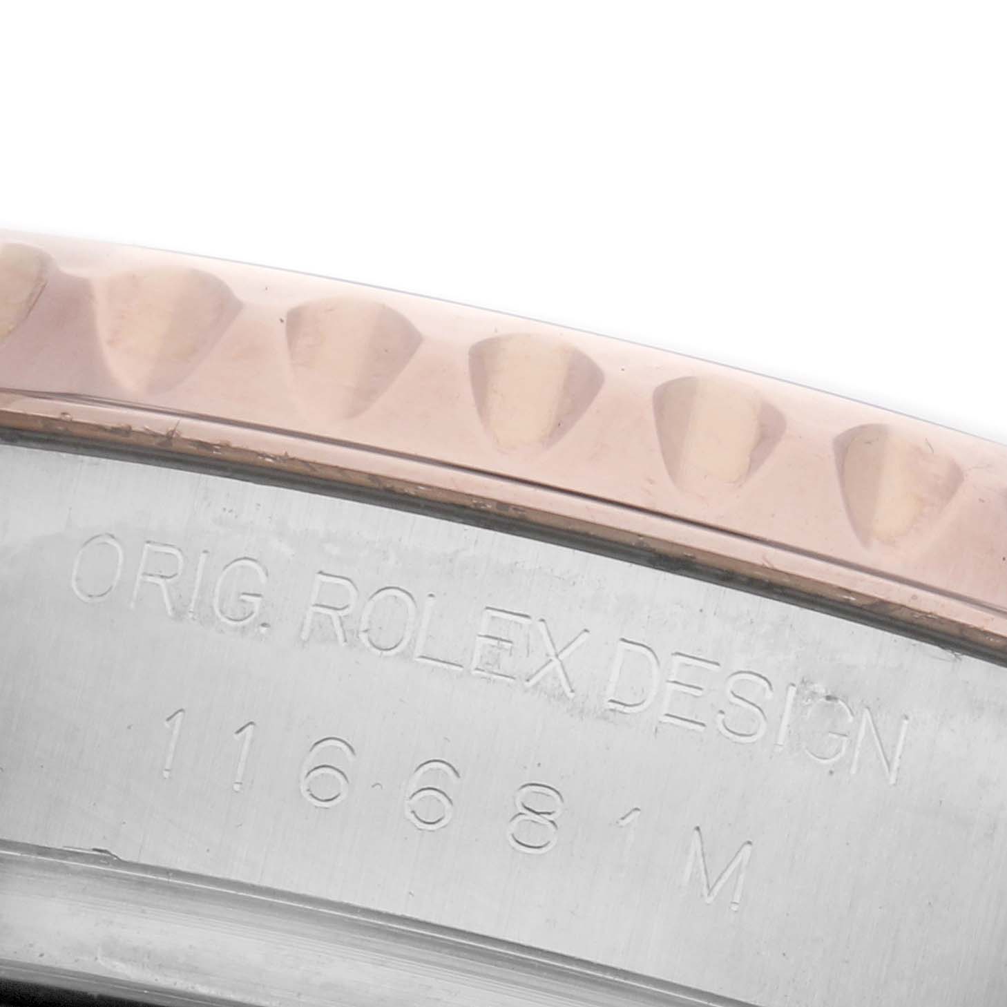 The image shows a close-up of the bezel and engraved serial number of a Rolex Yacht-Master 116681 Men's Steel and Gold (two tone) White Dial 116681 Men's Steel and Gold (two tone) White Dial watch.