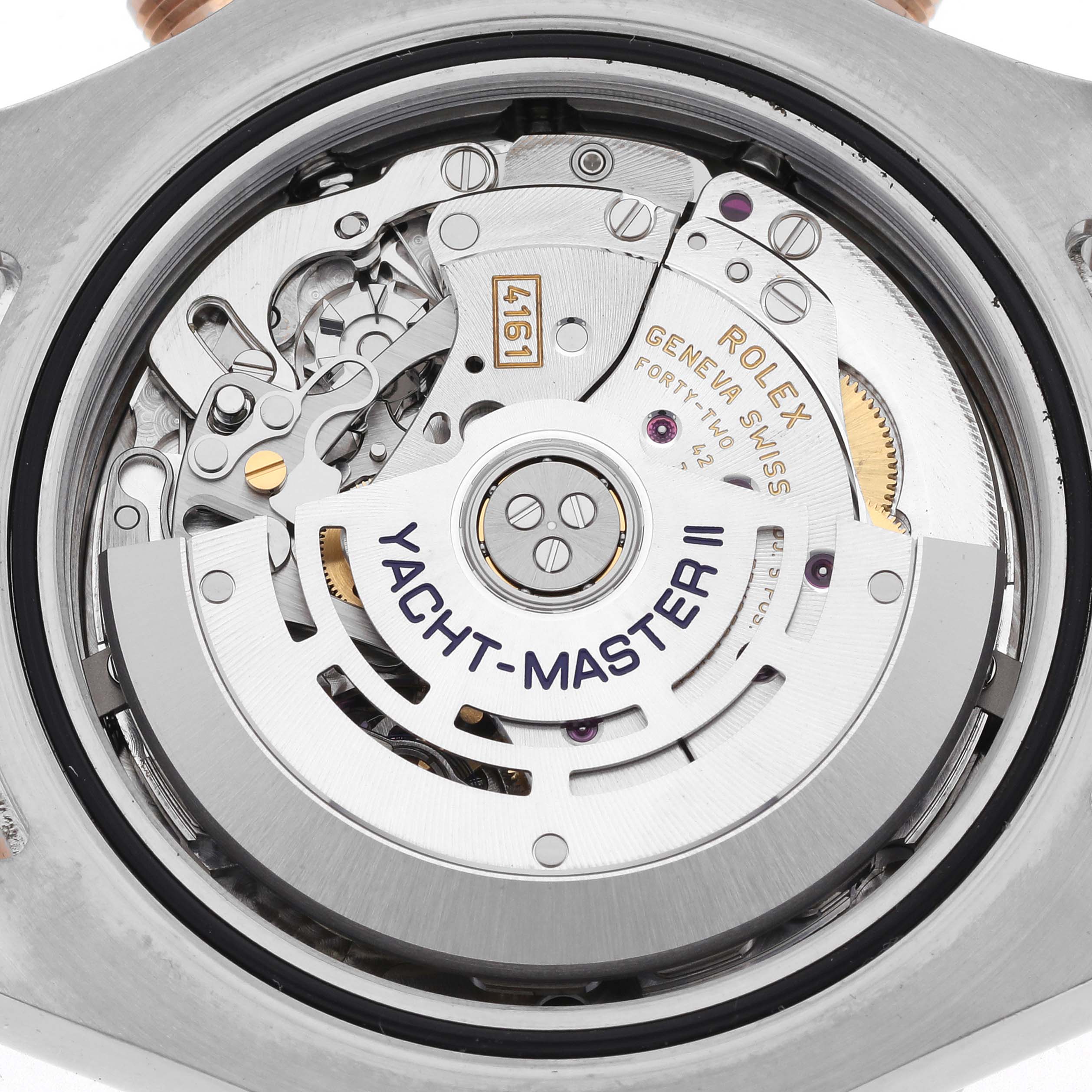 The image shows the movement of the Rolex Yacht-Master 116681 Men's Steel and Gold (two tone) White Dial 116681 Men's Steel and Gold (two tone) White Dial II watch, viewed from the back, highlighting the rotor and intricate components.