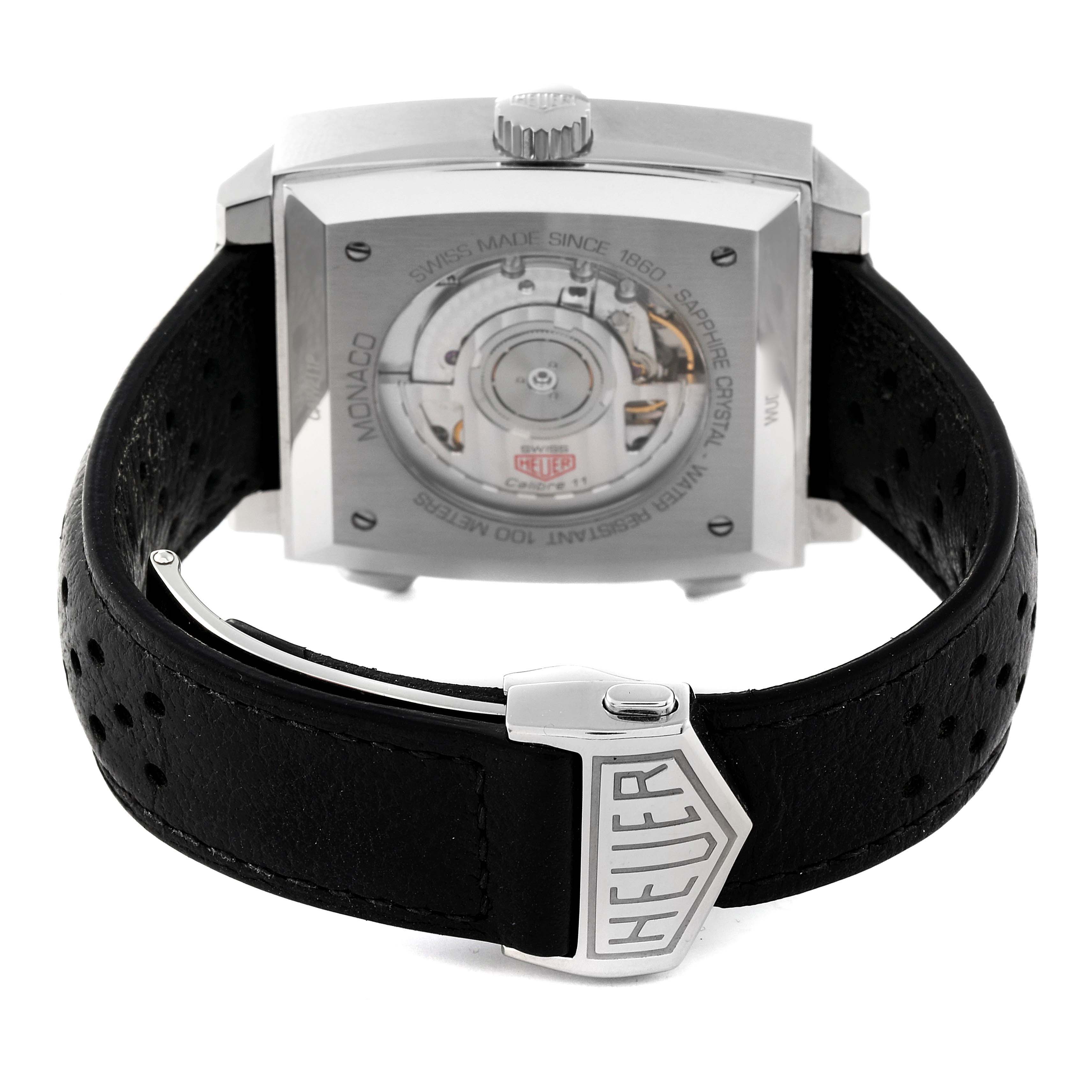 The image shows the back view of the Tag Heuer Monaco CAW211P.FC6356 Men's Stainless Steel Blue Dial CAW211P.FC6356 Men's Stainless Steel Blue Dial watch, including the movement mechanism and leather strap with a Heuer clasp.