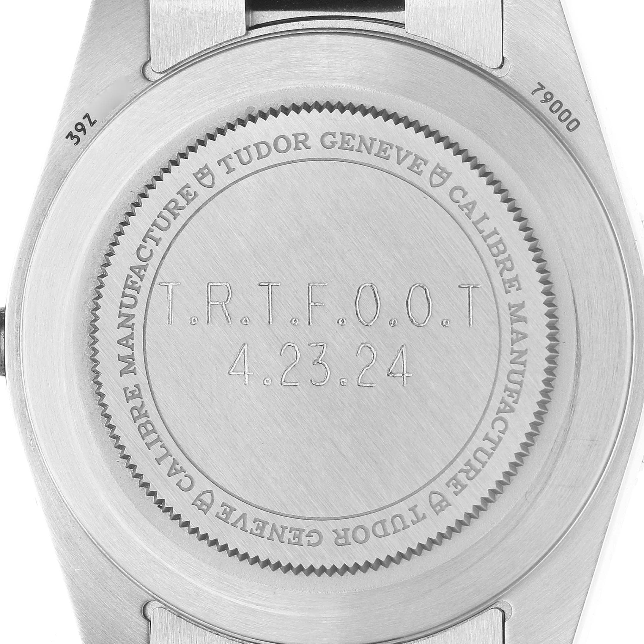The image shows the back of a Tudor Heritage Black Bay M79000N-0002 Men's Stainless Steel Black Dial watch, highlighting the engraved case back.