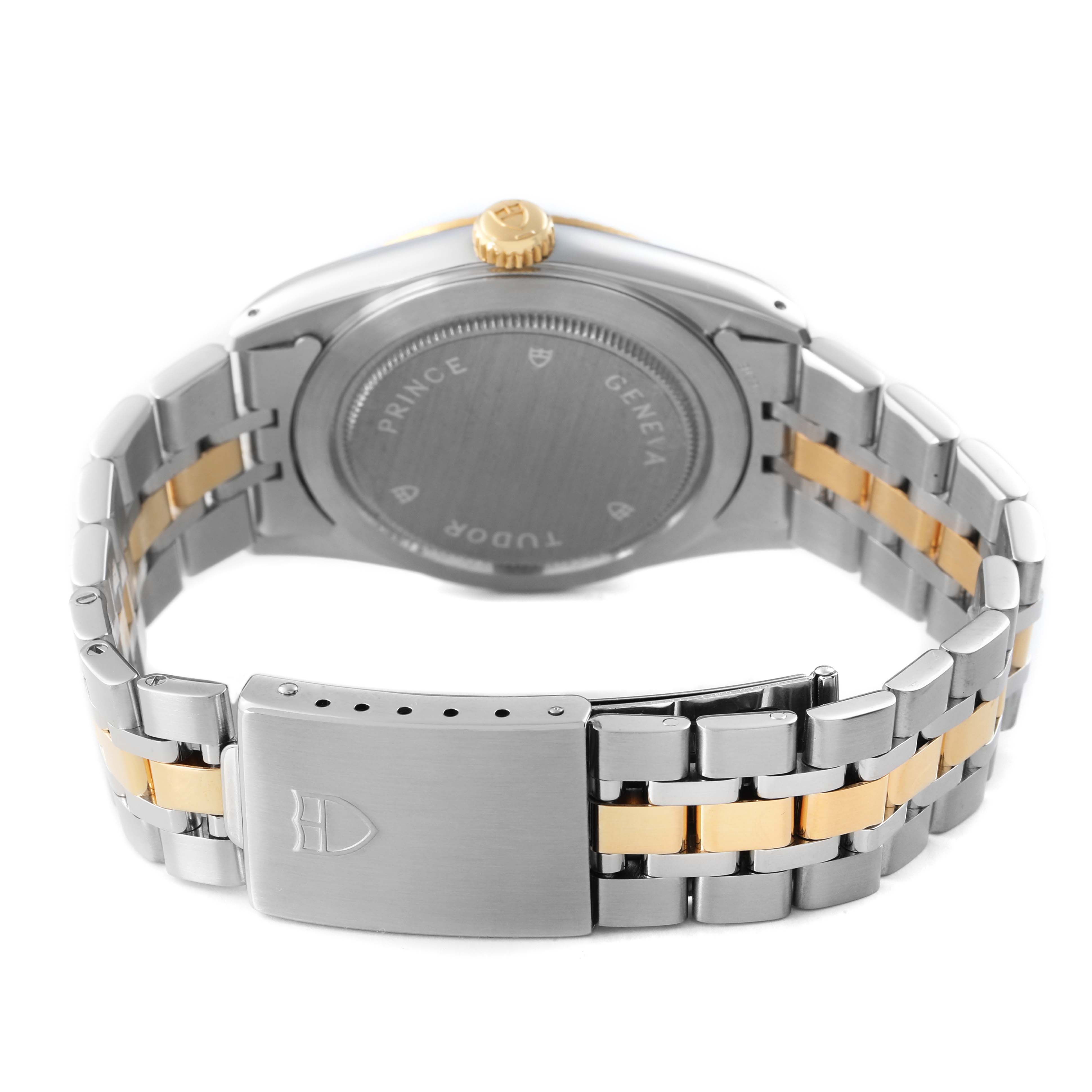 The Tudor Prince M76213 Men's Steel and Gold (two tone) Black Dial watch is shown from the back, highlighting the case back, crown, and two-tone metal bracelet with a clasp.