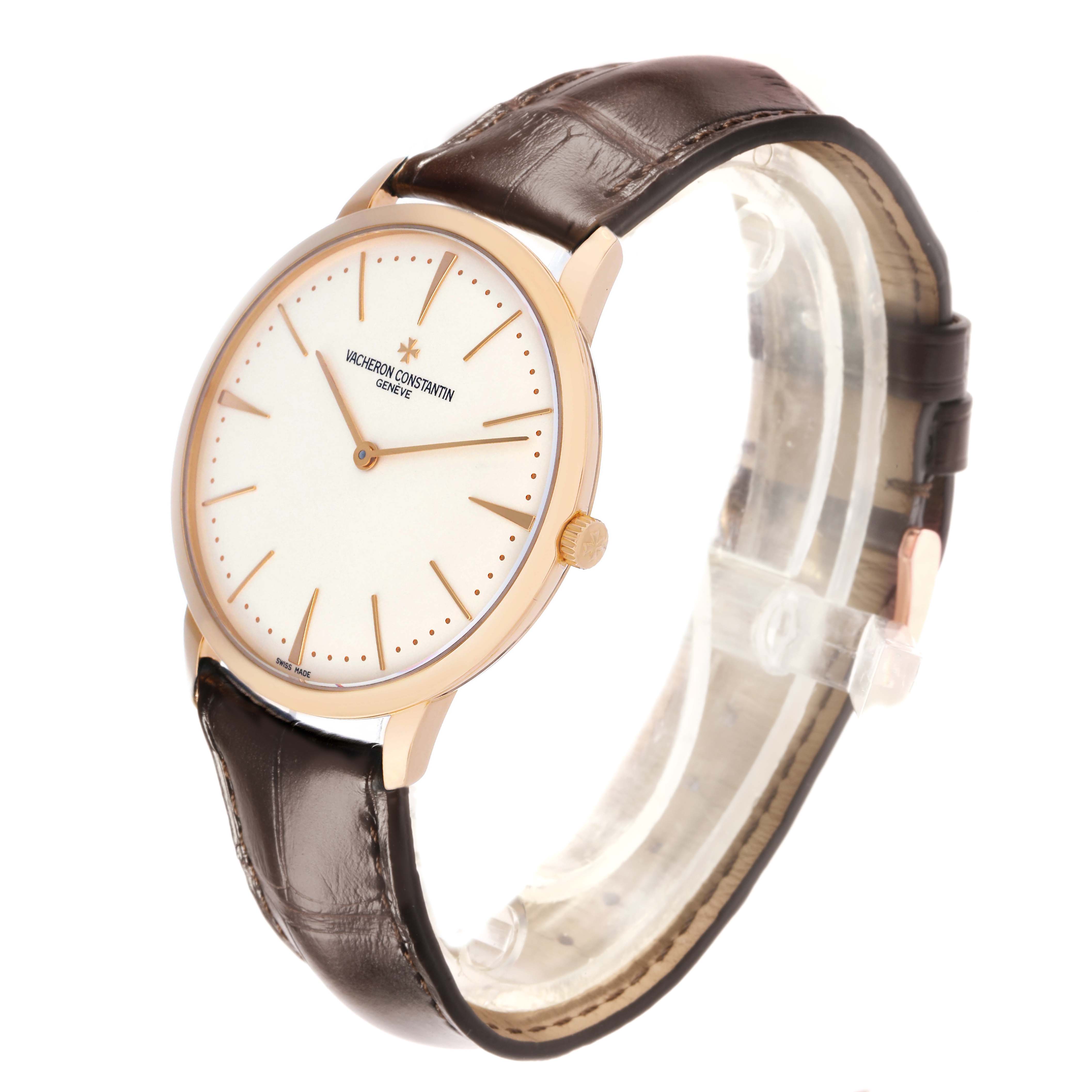 The Vacheron Constantin Patrimony 81180/000R-9159 Men's Rose Gold Silver Dial watch is shown at a tilted angle, highlighting its face, bezel, and leather strap.