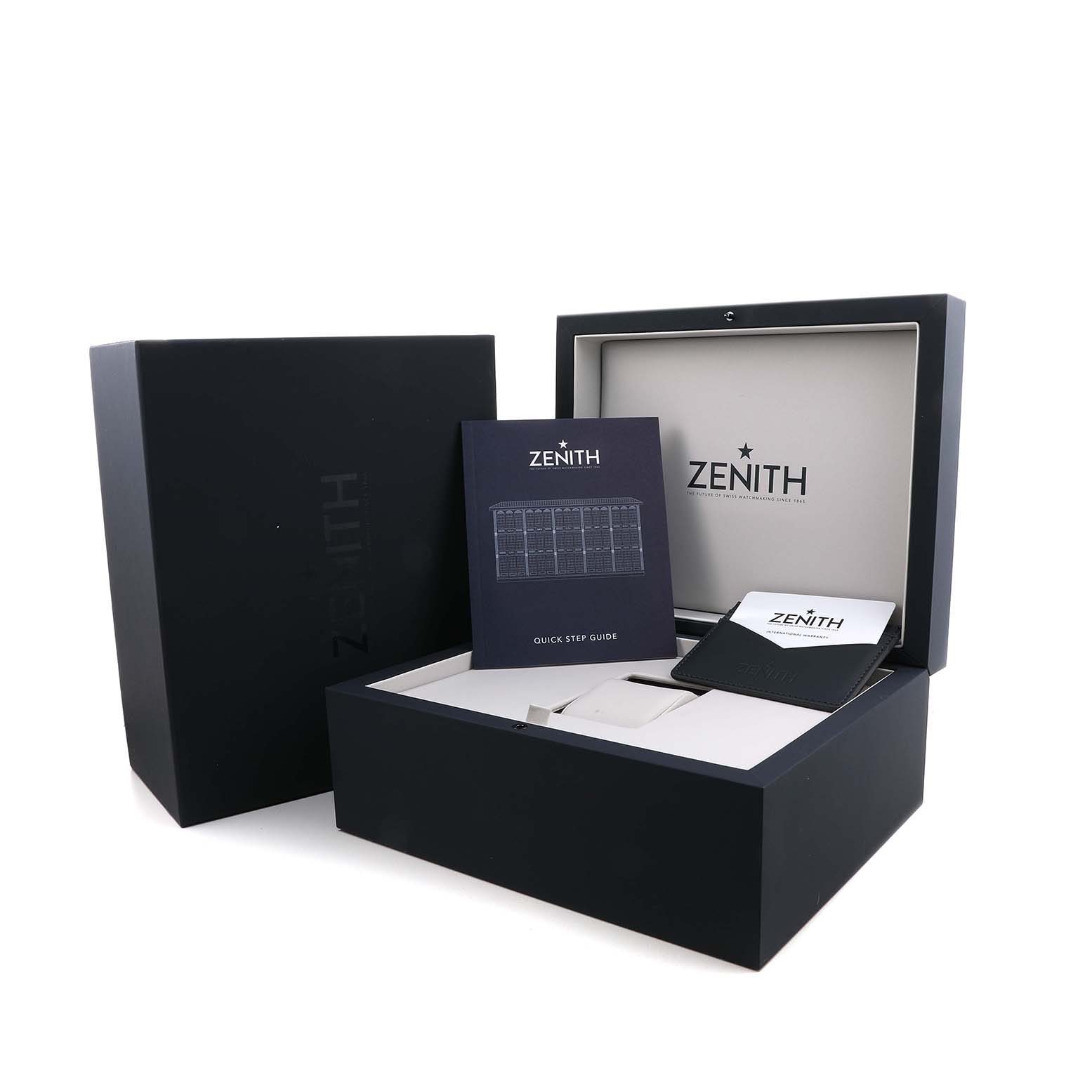The image shows a Zenith Chronomaster 03.3105.3600/52.M3100 Men's Stainless Steel Blue Dial watch box and accessories, including a manual and card holder, viewed from above.