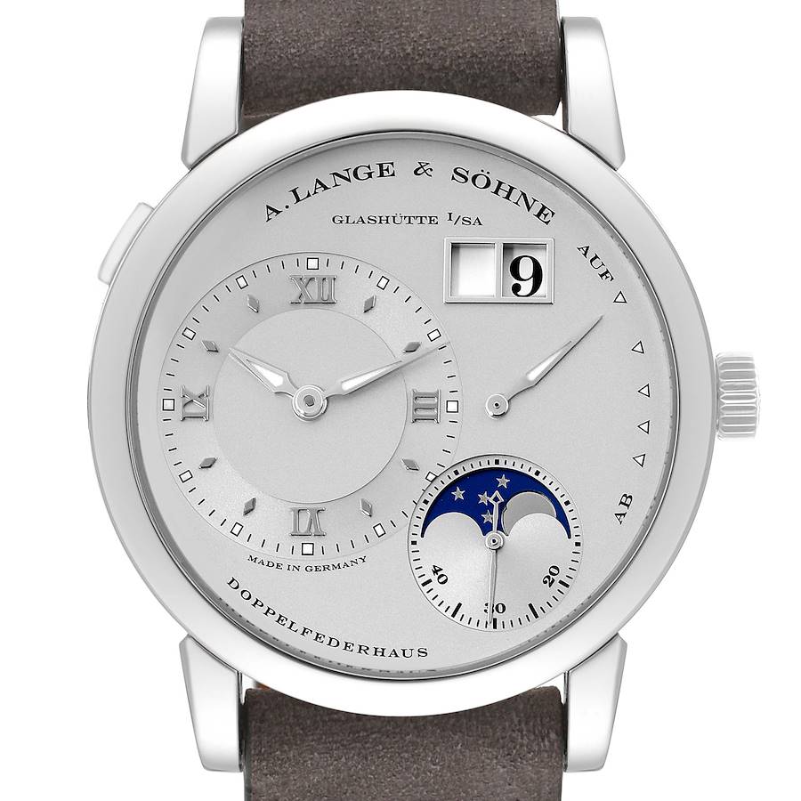 The Lange 1 model by A. Lange & Söhne is shown head-on, displaying the dial, hour markers, hands, date window, and moon phase indicator.