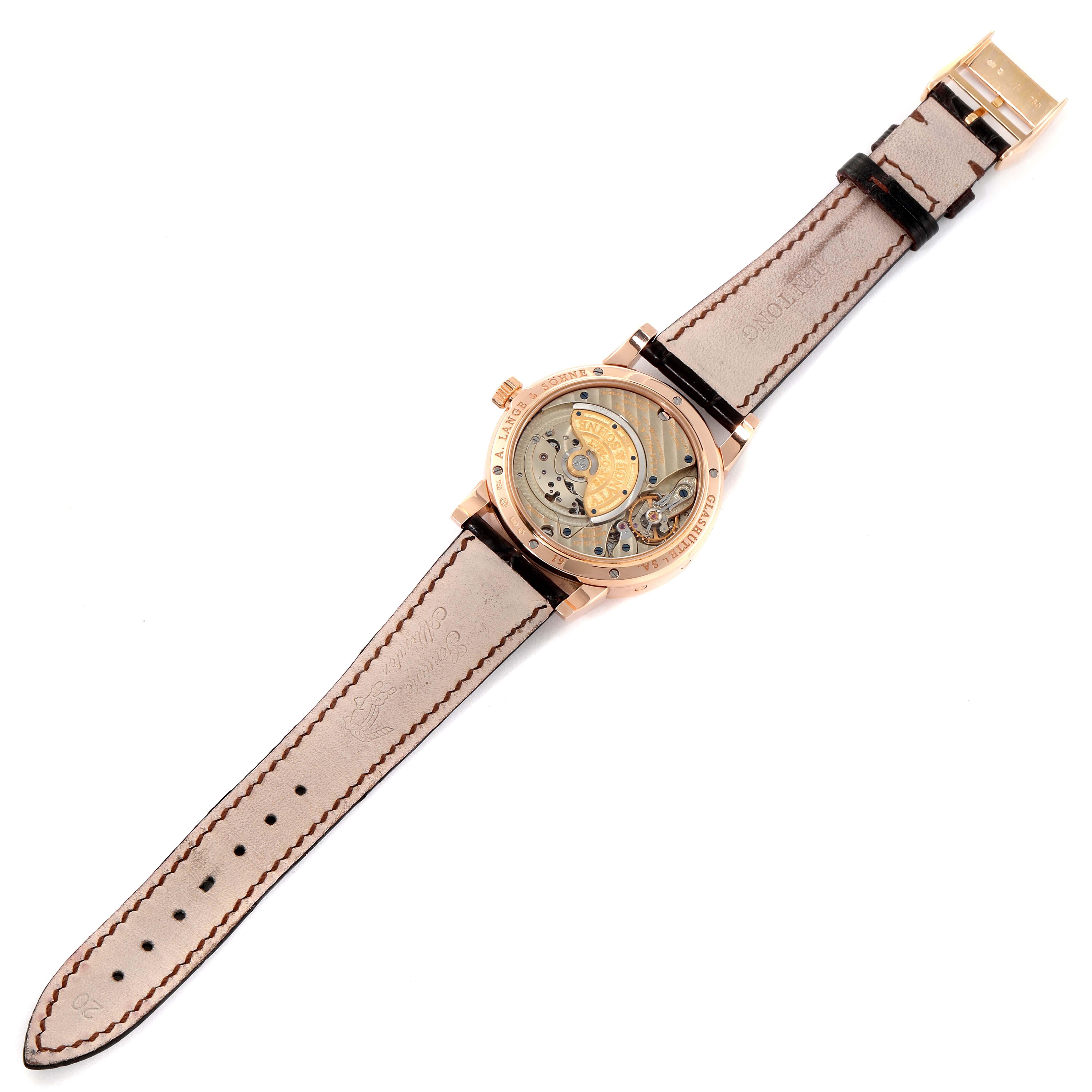 The image shows the back view of the A. Lange & Sohne Saxonia 330.032 Men's Rose Gold Silver Dial watch, displaying its inner mechanisms and leather strap.