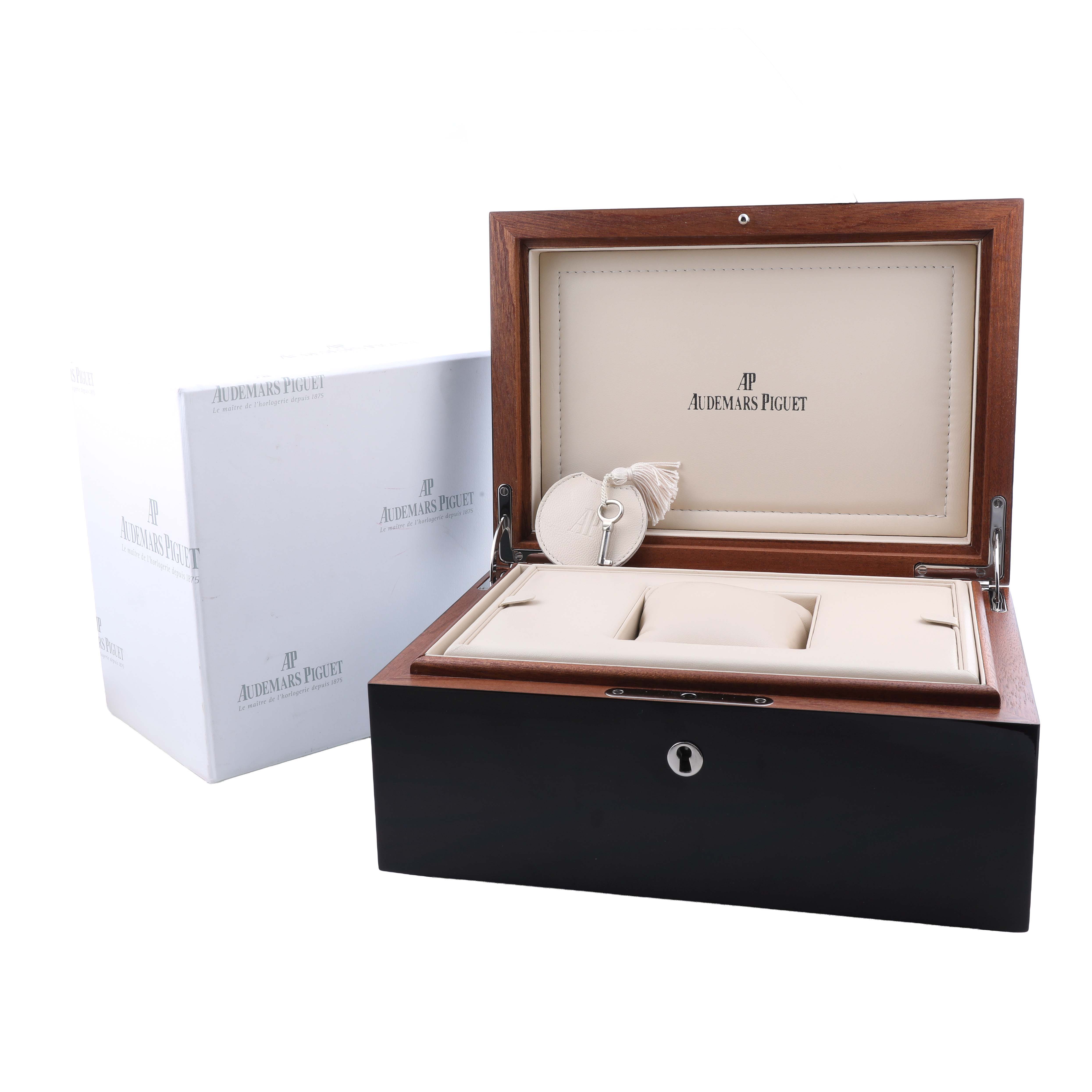 The image shows an open Audemars Piguet Millenary 15330OR.ZZ.D102CR.01 Women's Rose Gold Pink Dial watch box at an angle, displaying its interior compartments and branding.