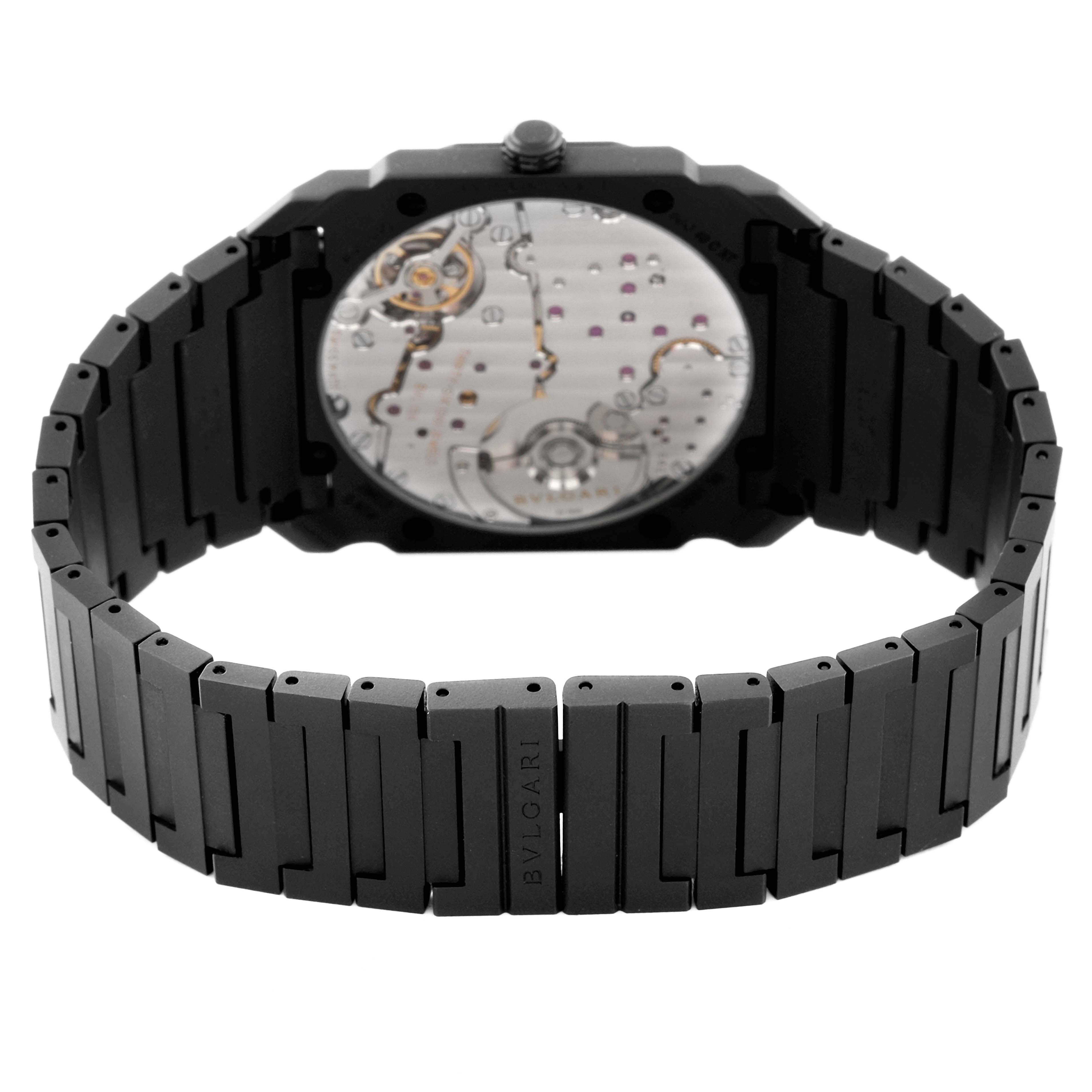 The image shows the back view of a Bvlgari Octo 103077 Men's Ceramic Black Dial 103077 Men's Ceramic Black Dial model watch, highlighting the movement and bracelet.