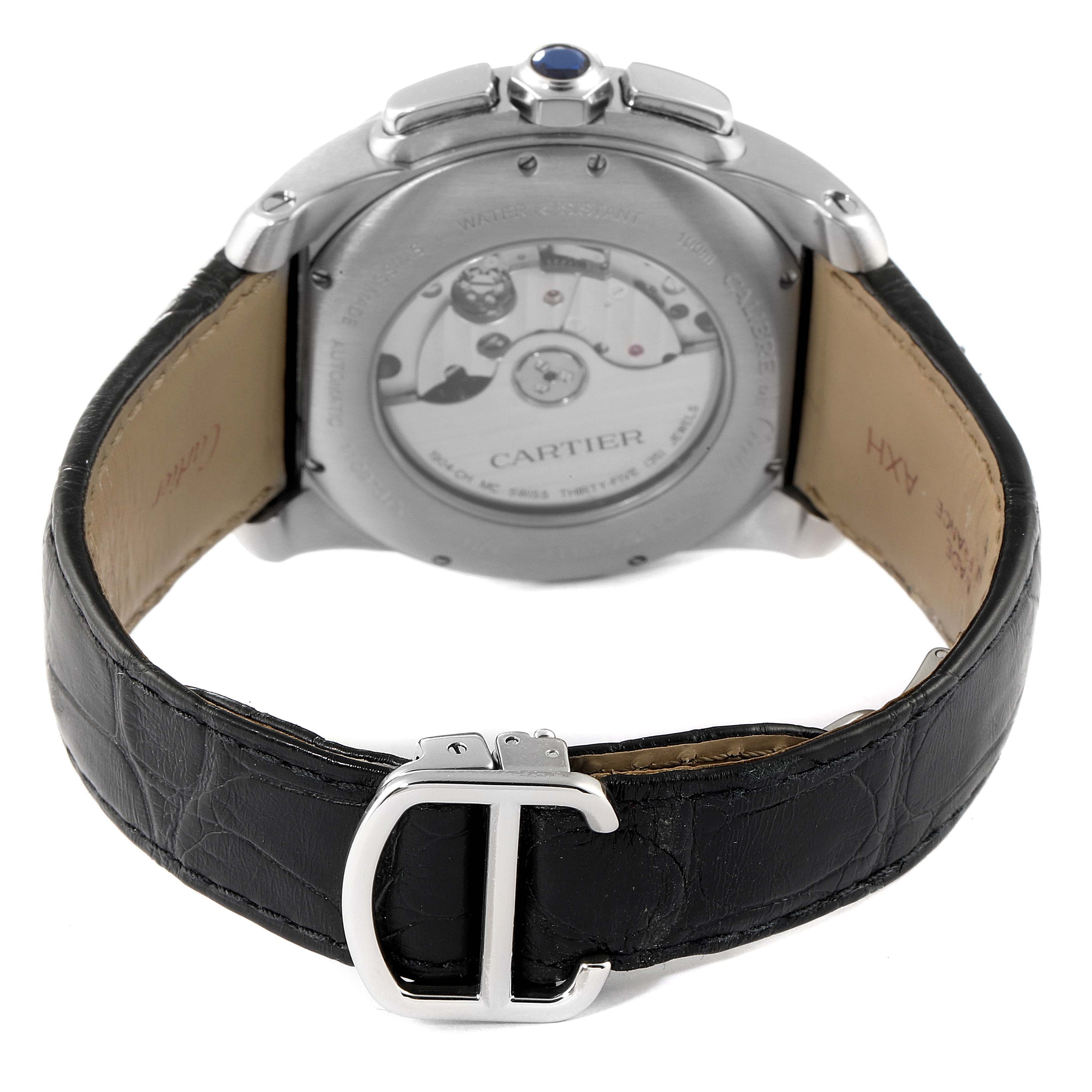 The image shows the back view of a Calibre de Cartier watch by Cartier, highlighting the transparent case back and leather strap.