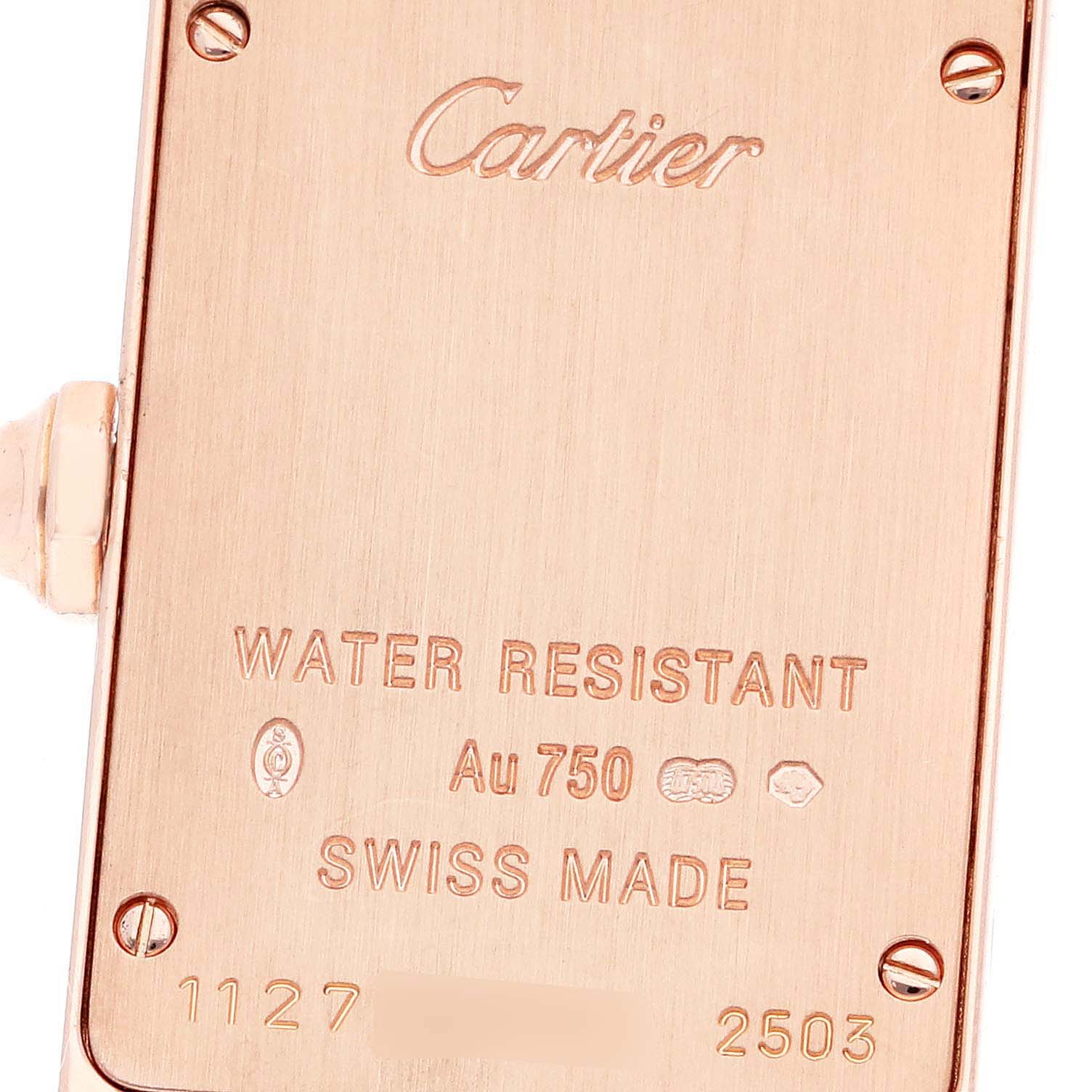 This image shows the back of a Tank Americaine watch by Cartier, engraved with specifications and hallmarks.