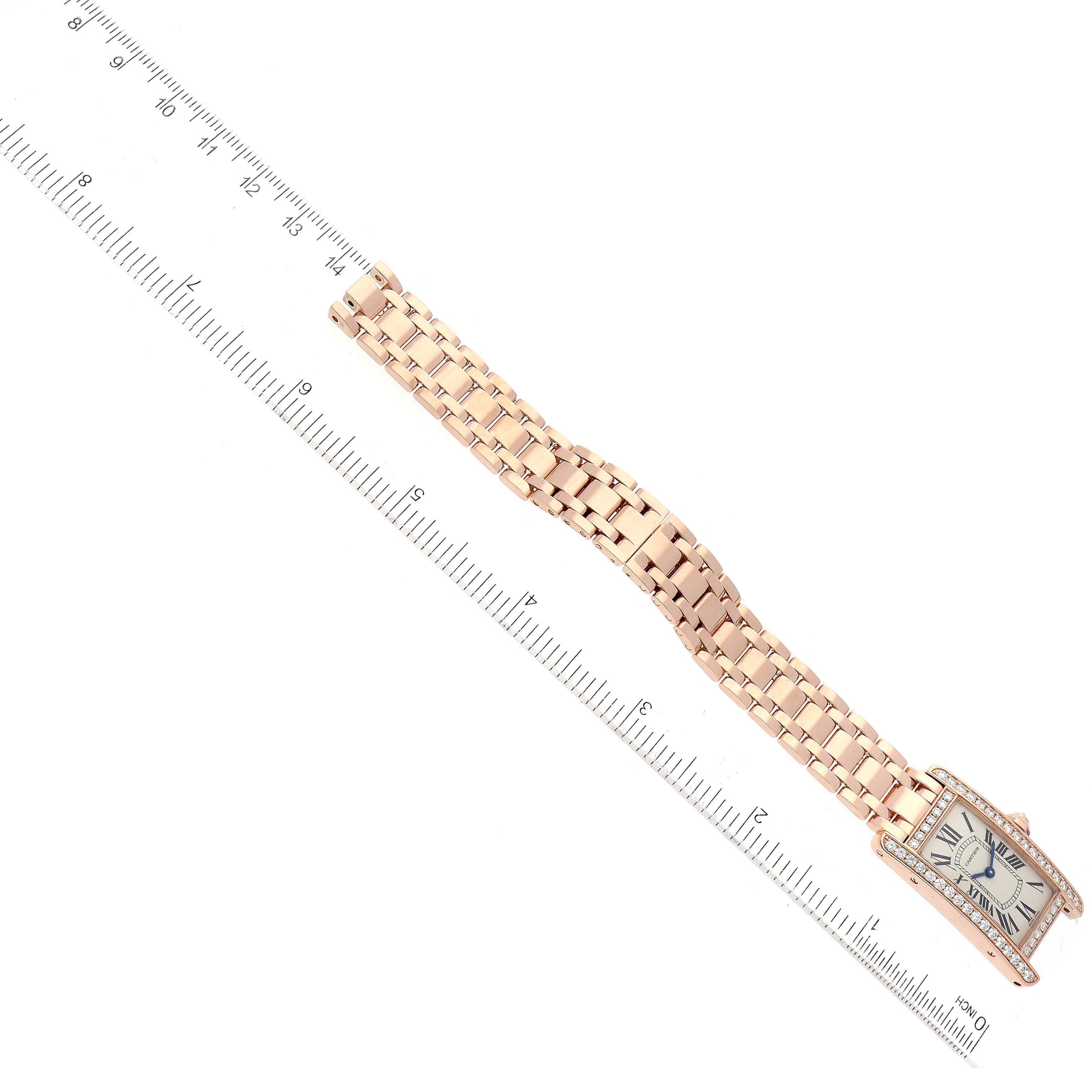 This image shows a Cartier Tank Américaine watch laid flat next to a ruler, highlighting its band and face.
