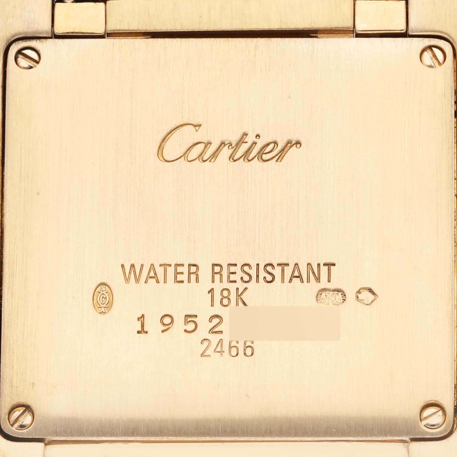 The image shows the backside of a Cartier Tank Francaise W50014N2 Women's Yellow Gold Silver Dial W50014N2 Women's Yellow Gold Silver Dial watch case, highlighting its engravings and markings.