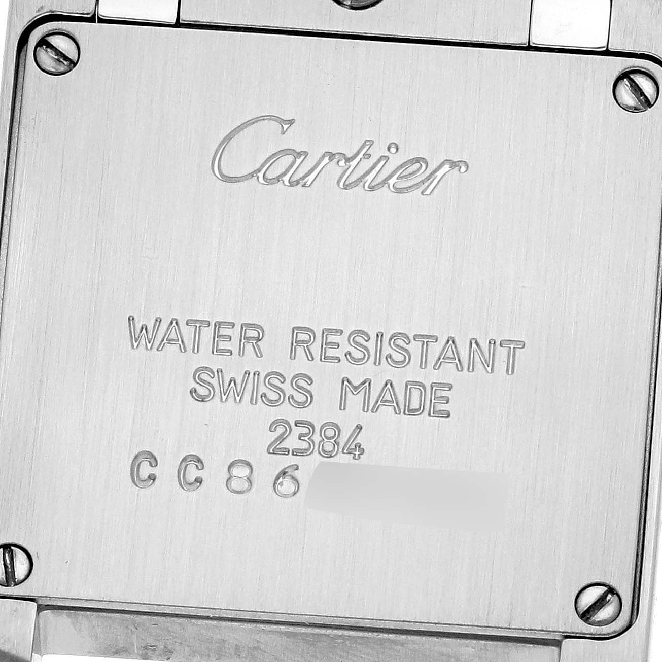 This is a close-up view of the back case of a Cartier Tank Française watch, showing its engravings.