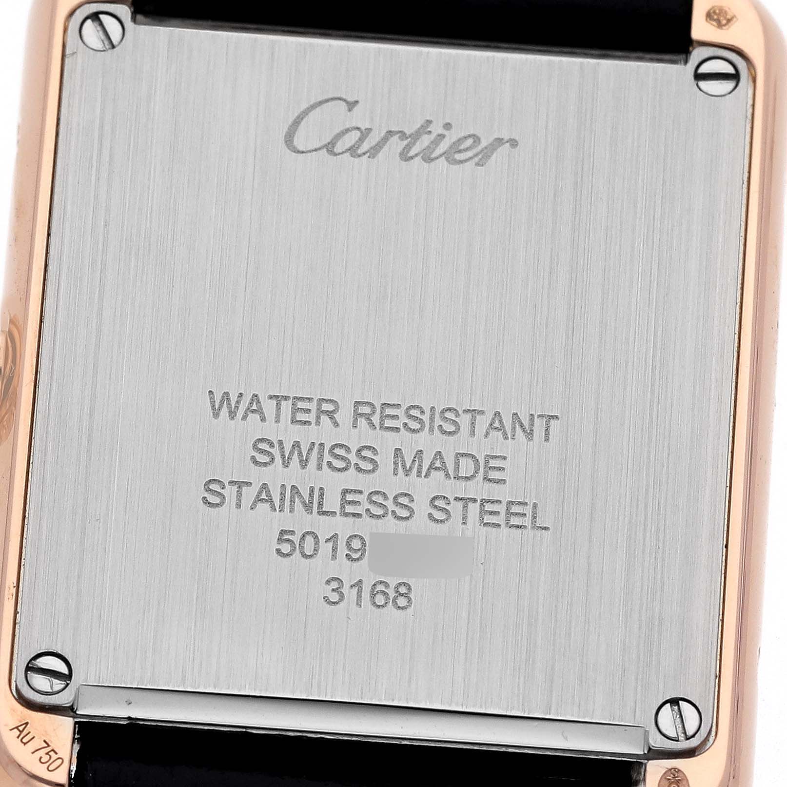 The image shows the back casing of the Cartier Tank Solo W5200024 Women's Steel and Gold (two tone) Silver Dial W5200024 Women's Steel and Gold (two tone) Silver Dial watch, displaying "Cartier" and specifications on water resistance, origin, and material.
