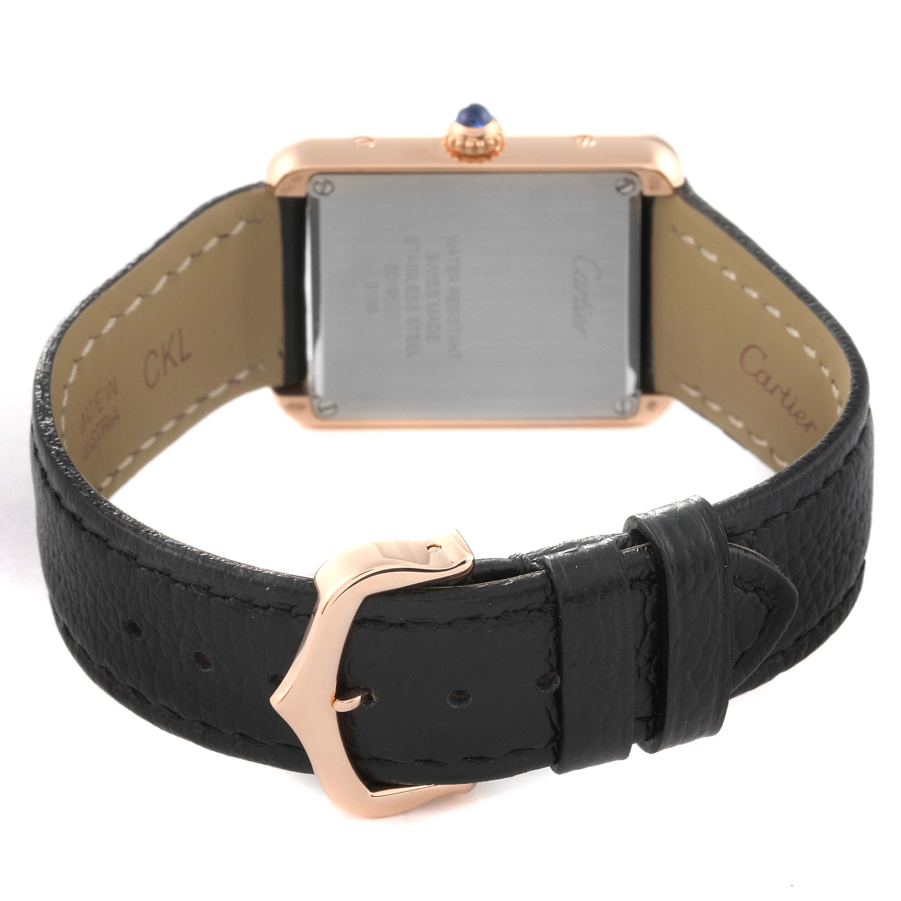 The image shows the back of a Cartier Tank Solo W5200024 Women's Steel and Gold (two tone) Silver Dial W5200024 Women's Steel and Gold (two tone) Silver Dial watch with a black leather strap and rose gold buckle.