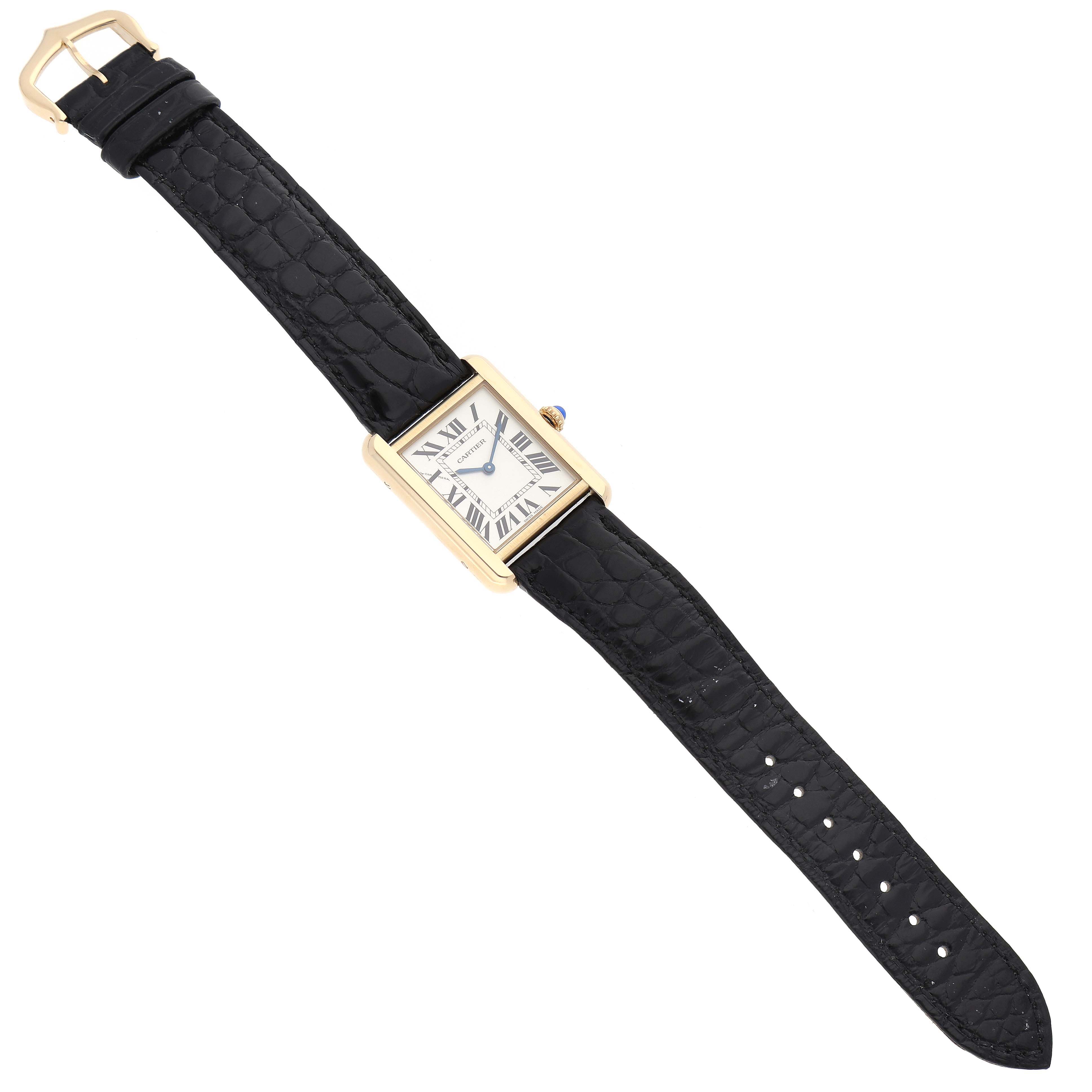 The image shows the Cartier Tank Solo W1018755 Women
s Steel and Gold (two tone) Silver Dial W1018755 Women
s Steel and Gold (two tone) Silver Dial watch from a top-down angle, displaying its face and black leather strap.