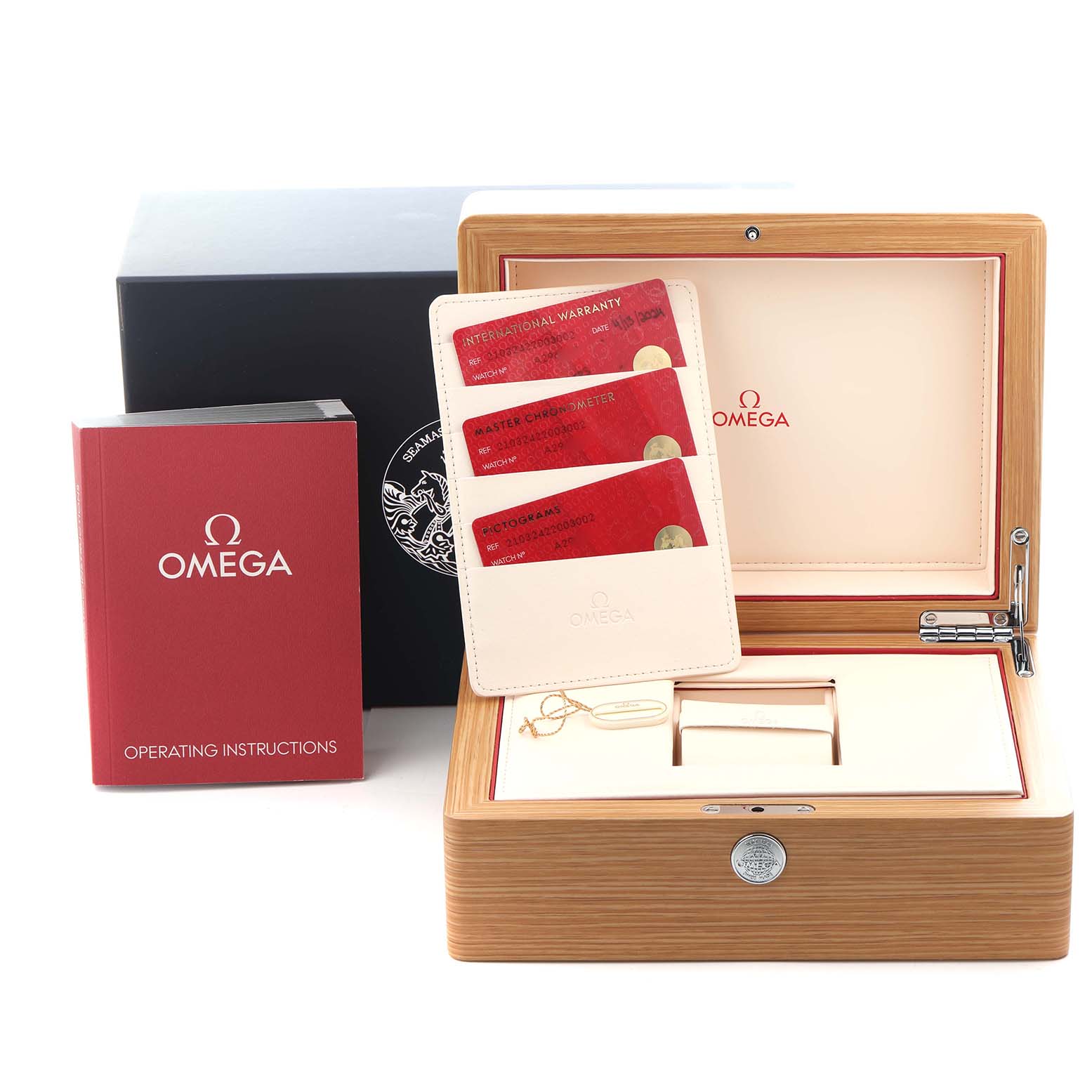 The image shows the open box and accessories for an Omega Seamaster 210.32.42.20.03.002 Men's Stainless Steel Blue Dial 210.32.42.20.03.002 Men's Stainless Steel Blue Dial, including warranty cards and an instruction manual.