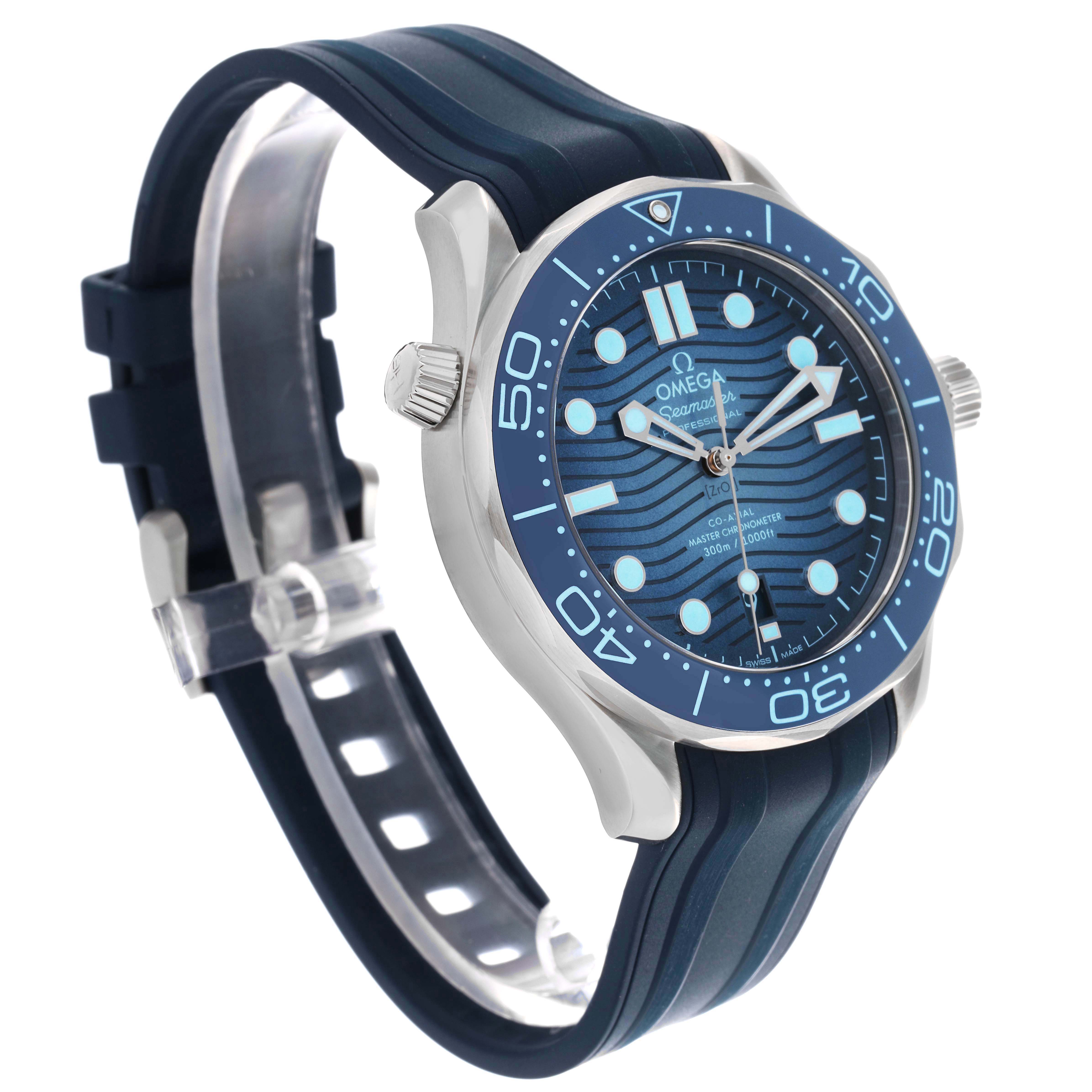 The Omega Seamaster 210.32.42.20.03.002 Men's Stainless Steel Blue Dial 210.32.42.20.03.002 Men's Stainless Steel Blue Dial watch is shown at a 3/4 angle, highlighting the face, bezel, crown, and blue rubber strap.