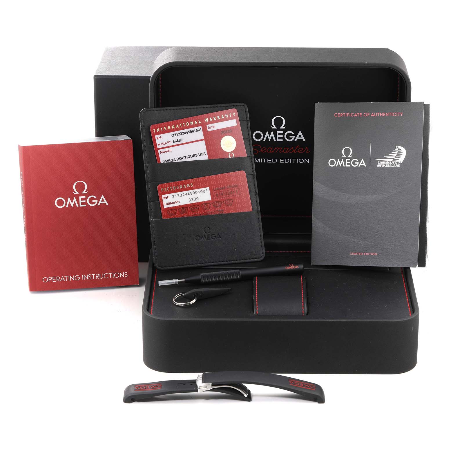 The image shows the packaging and accessories of an Omega Seamaster 212.32.44.50.01.001 Men's Stainless Steel Black Dial 212.32.44.50.01.001 Men's Stainless Steel Black Dial, including warranty cards, manuals, a tool, and a strap.