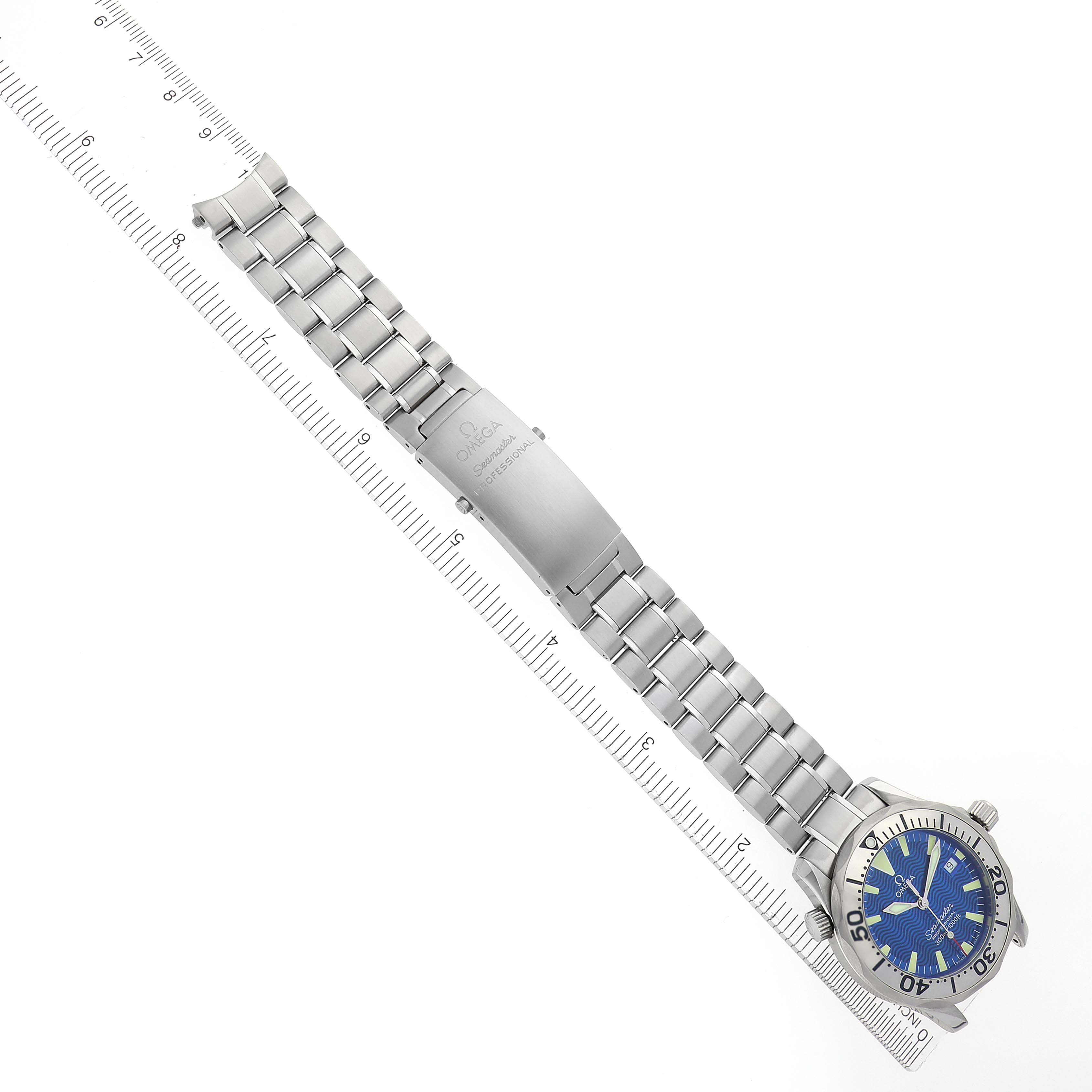 The Omega Seamaster 2263.80.00 Men's Stainless Steel Blue Dial 2263.80.00 Men's Stainless Steel Blue Dial watch is shown from the top, displaying its band, clasp, and blue dial alongside a ruler.