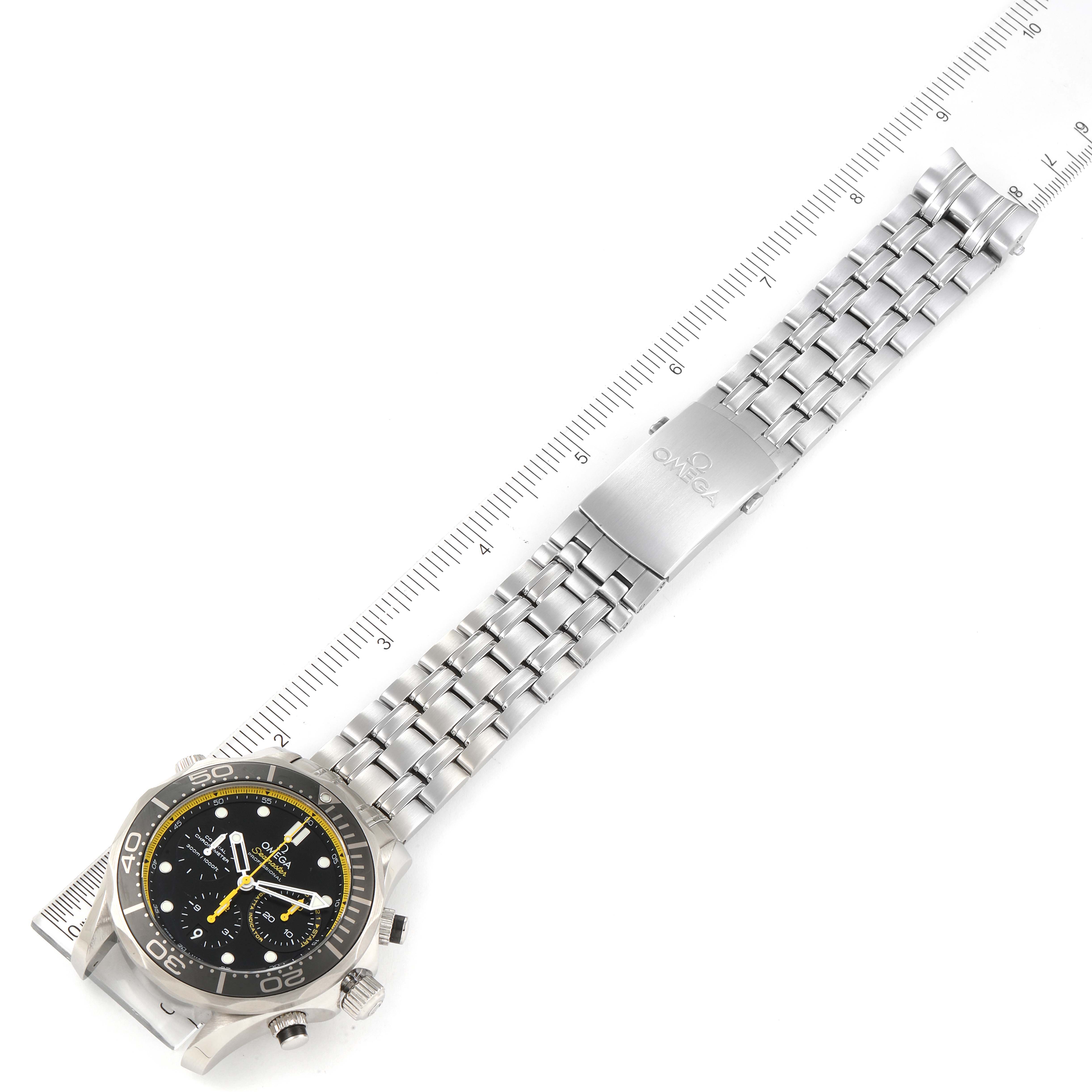 The Omega Seamaster 212.30.44.50.01.002 Men's Stainless Steel Black Dial 212.30.44.50.01.002 Men's Stainless Steel Black Dial watch is shown laid flat with its stainless steel bracelet extended and a ruler for measurement.