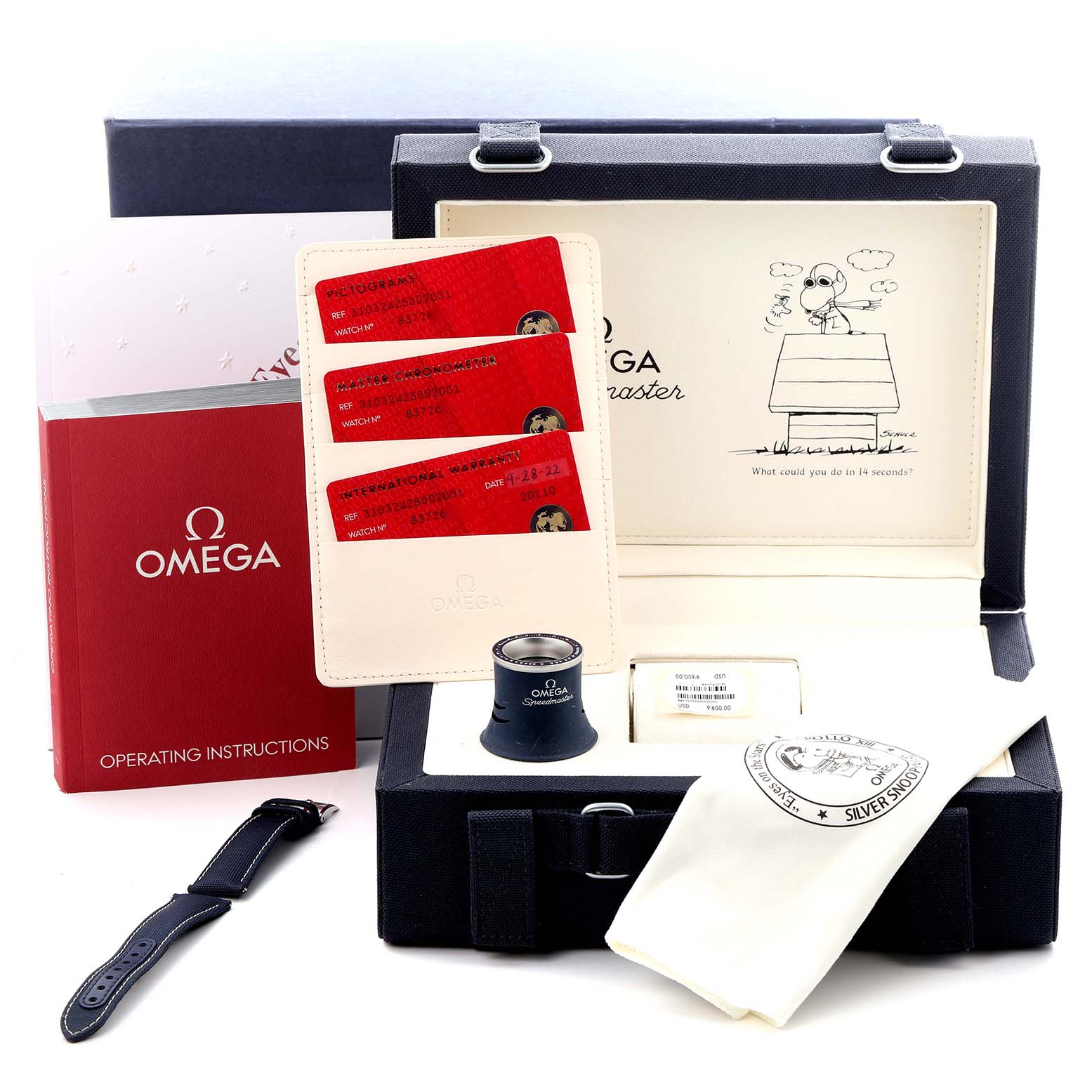 This image shows the Omega Speedmaster 310.32.42.50.02.001 Men's Stainless Steel Silver Dial 310.32.42.50.02.001 Men's Stainless Steel Silver Dial's box, warranty cards, manual, strap, magnifier, and cleaning cloth, all at a frontal angle.