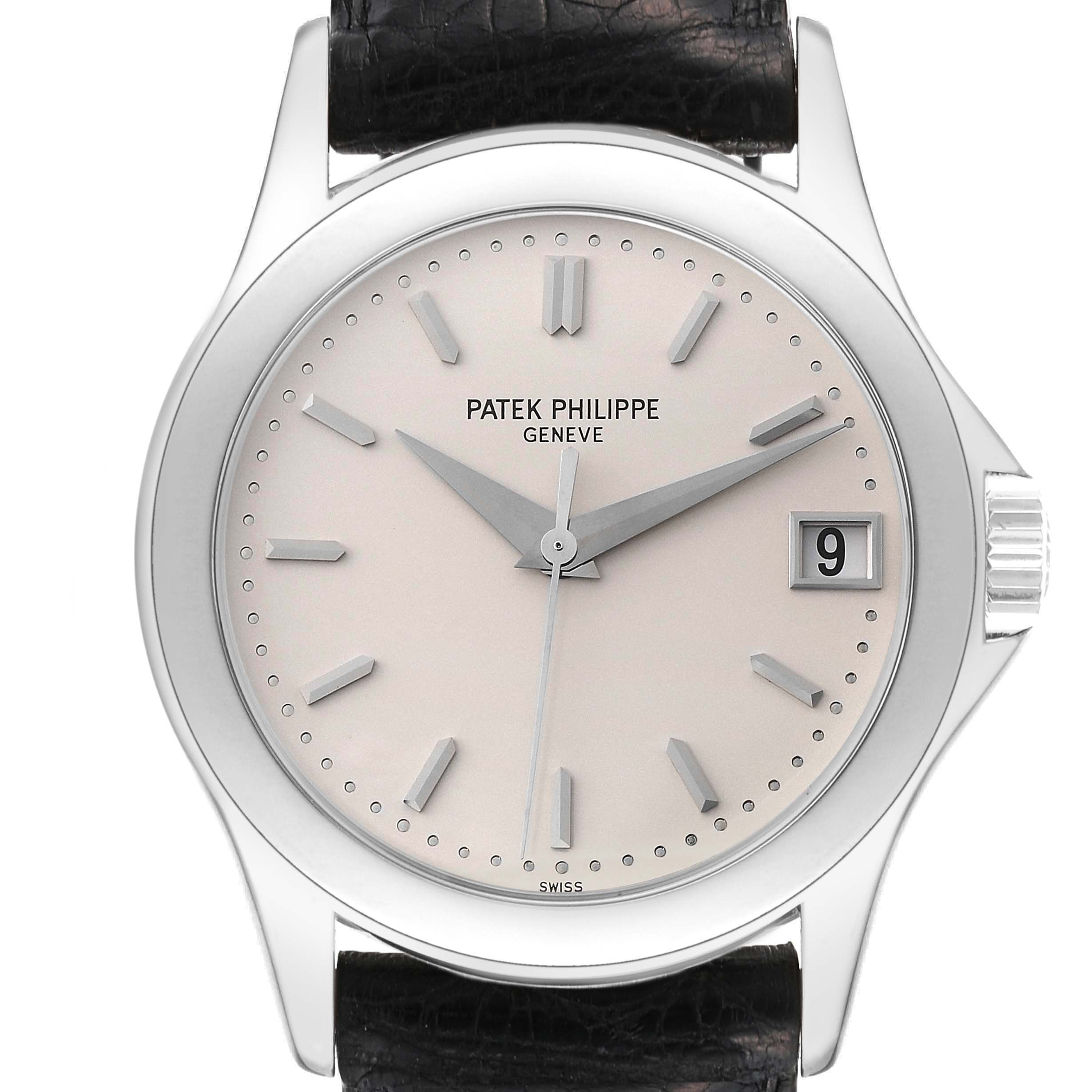 This image shows a front-facing view of a Patek Philippe Calatrava 5107G Men's White Gold Silver Dial 5107G Men's White Gold Silver Dial watch, featuring its dial, hands, case, and date window.