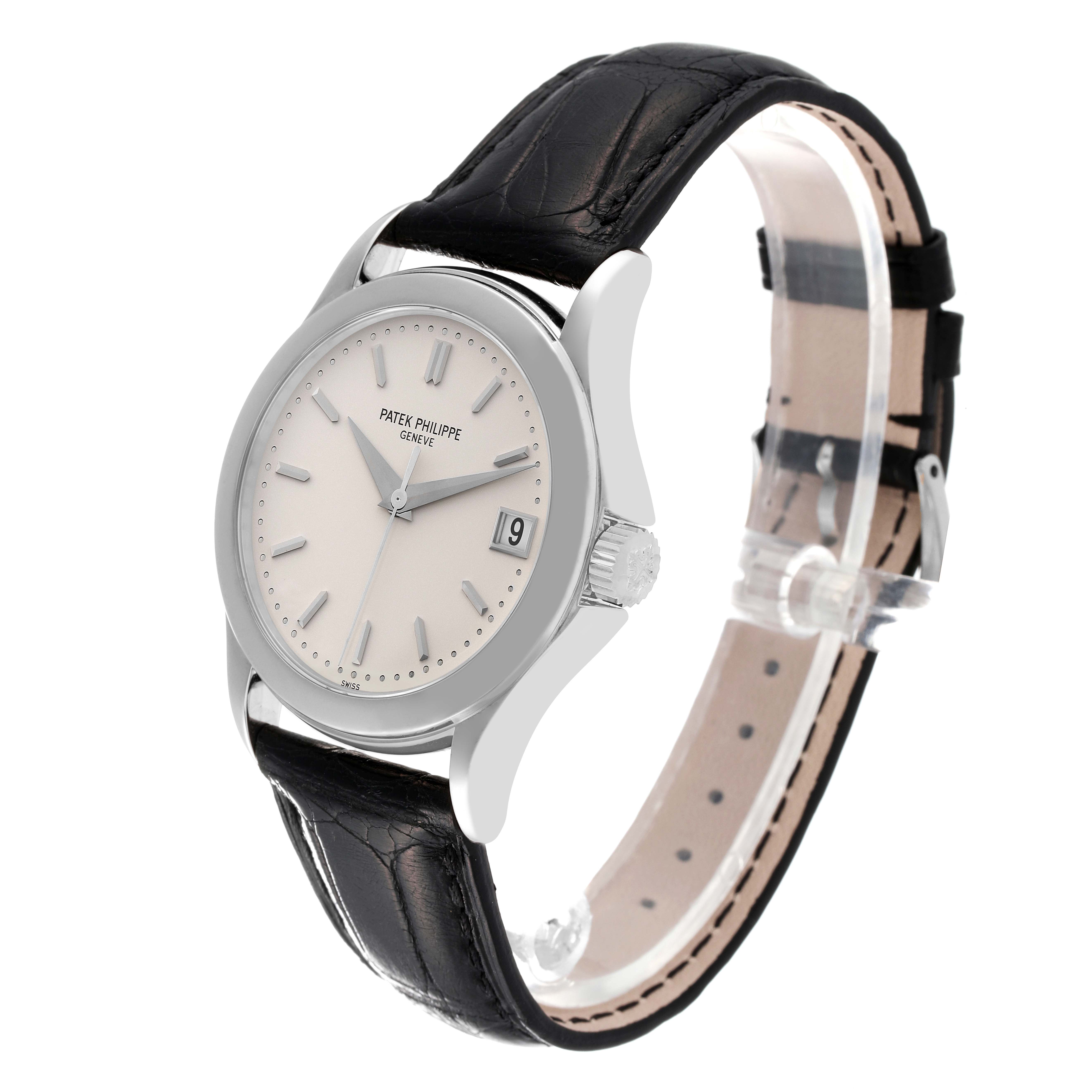 The image shows a Patek Philippe Calatrava 5107G Men's White Gold Silver Dial 5107G Men's White Gold Silver Dial watch from a three-quarter angle, highlighting its face, bezel, crown, and leather strap.
