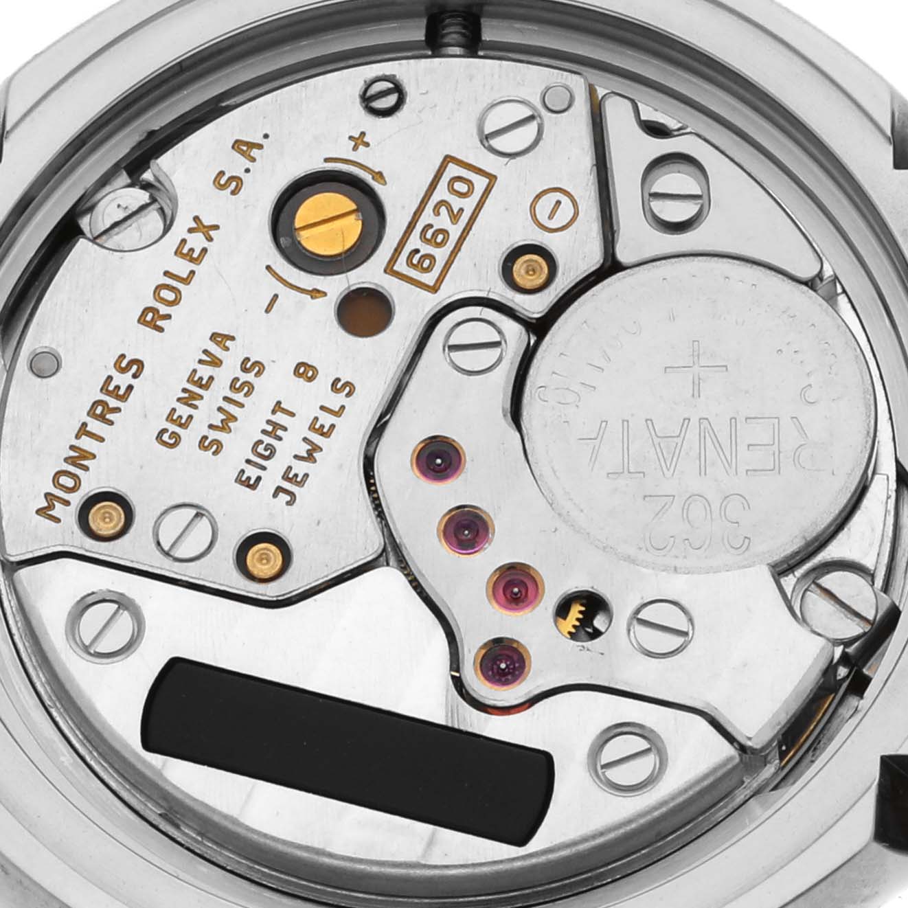 This image shows the inner mechanism and movement components of a Rolex Cellini 6673 Women's White Gold Mother of Pearl Dial 6673 Women's White Gold Mother of Pearl Dial watch, including gears and inscriptions.
