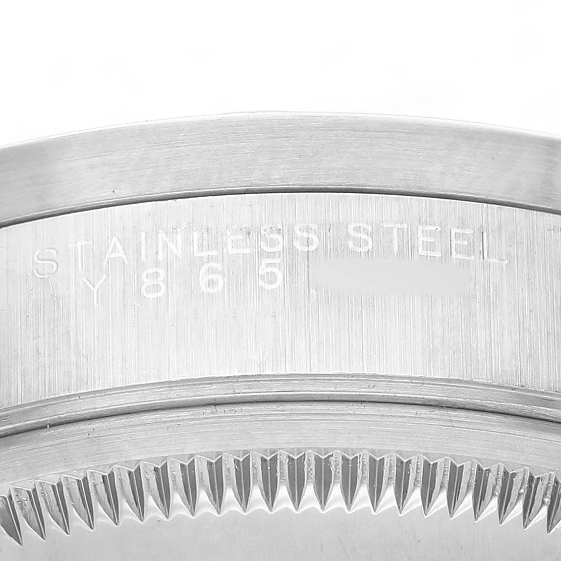 The image shows a close-up side view of the stainless steel case and bezel of a Rolex Date 15210 Men's Stainless Steel Blue Dial model watch.