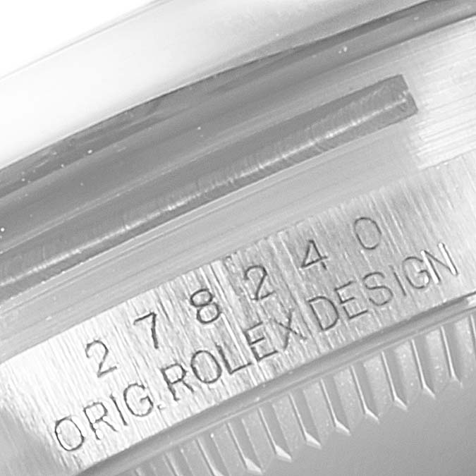 The image shows a close-up of the serial and model numbers engraved on the side of the Rolex Mid-Size 278240 Women's Stainless Steel Black Dial 278240 Women's Stainless Steel Black Dial watch case.