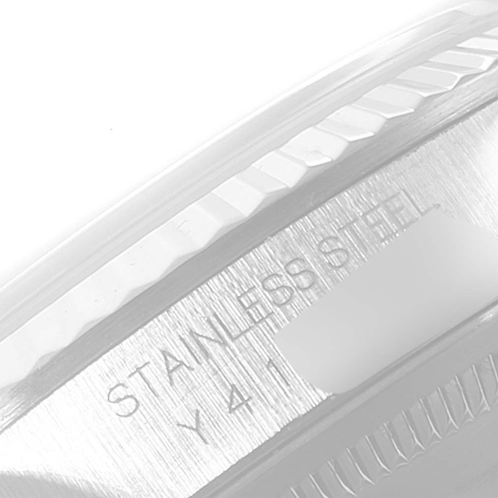 Close-up of the stainless steel case and engraved markings on a Rolex Datejust 16234 Men's Stainless Steel Blue Dial 16234 Men's Stainless Steel Blue Dial watch.