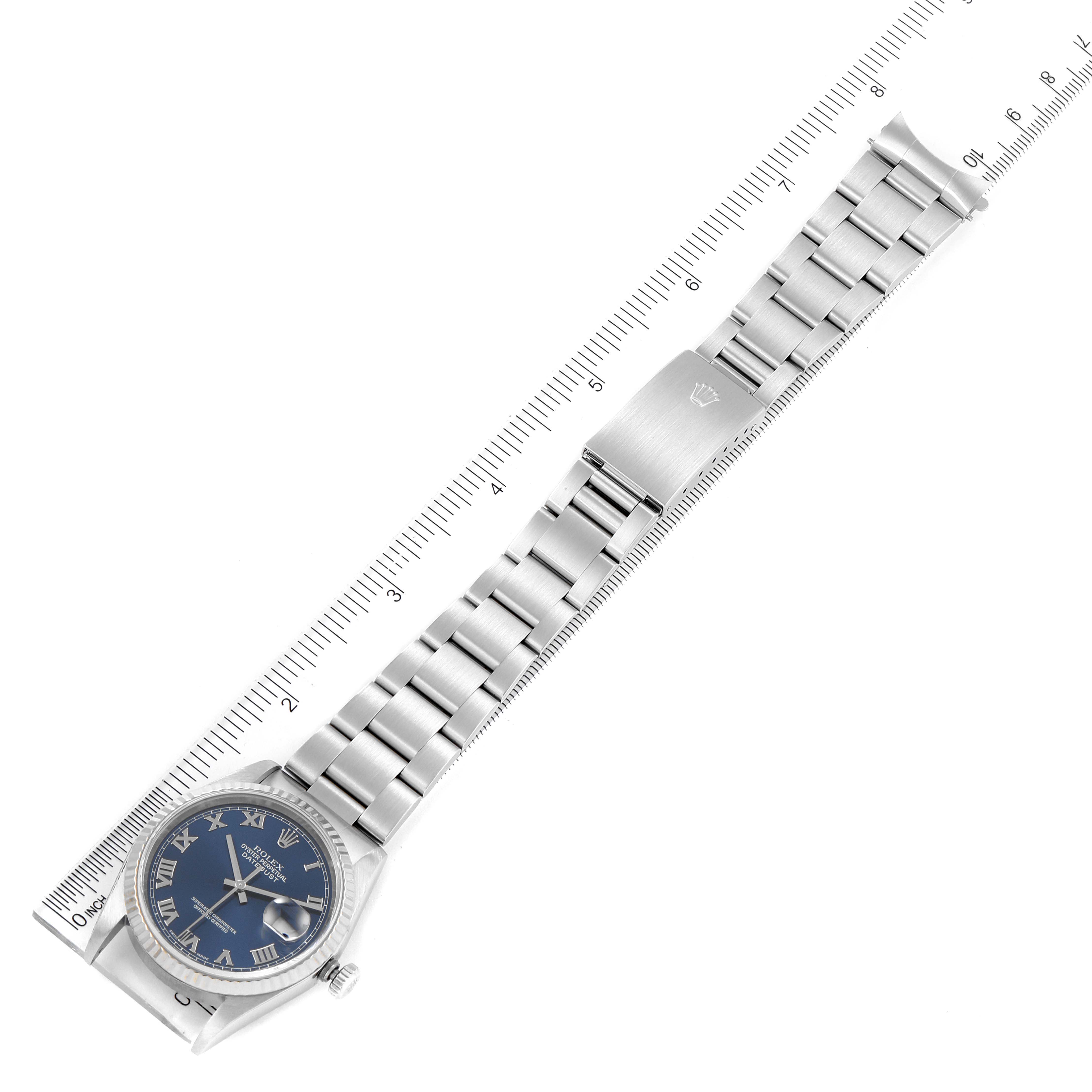 The image shows an overhead view of a Rolex Datejust 16234 Men's Stainless Steel Blue Dial 16234 Men's Stainless Steel Blue Dial watch, including the face, bezel, bracelet, and clasp with a ruler for scale.