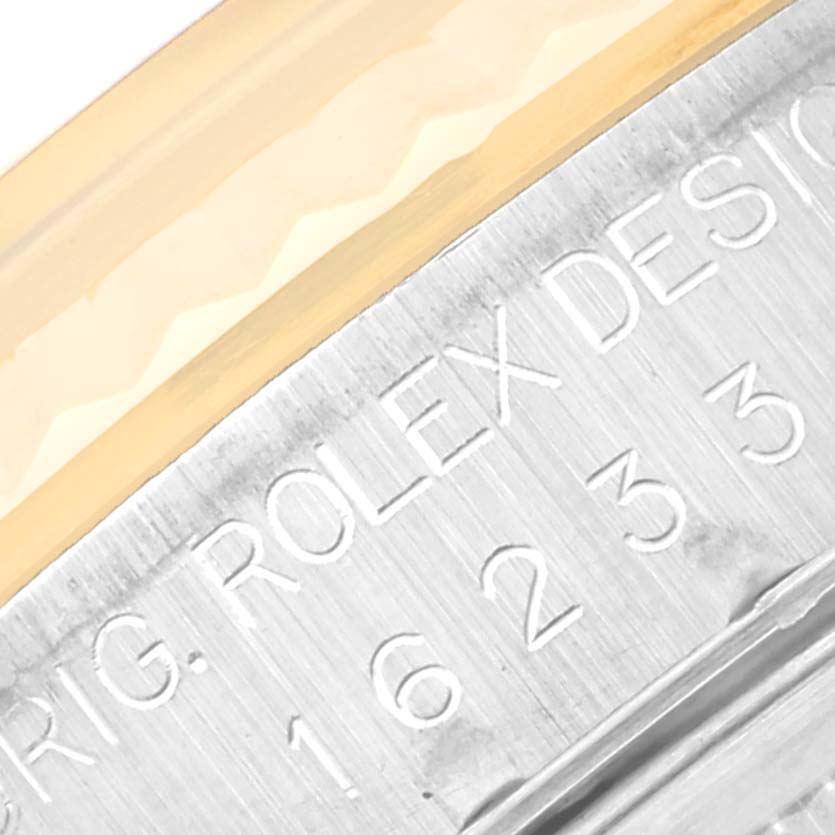 The image shows a close-up angle of the model and brand engravings on the case of a Rolex Datejust 16233 Men's Steel and Gold (two tone) Black Dial 16233 Men's Steel and Gold (two tone) Black Dial watch.