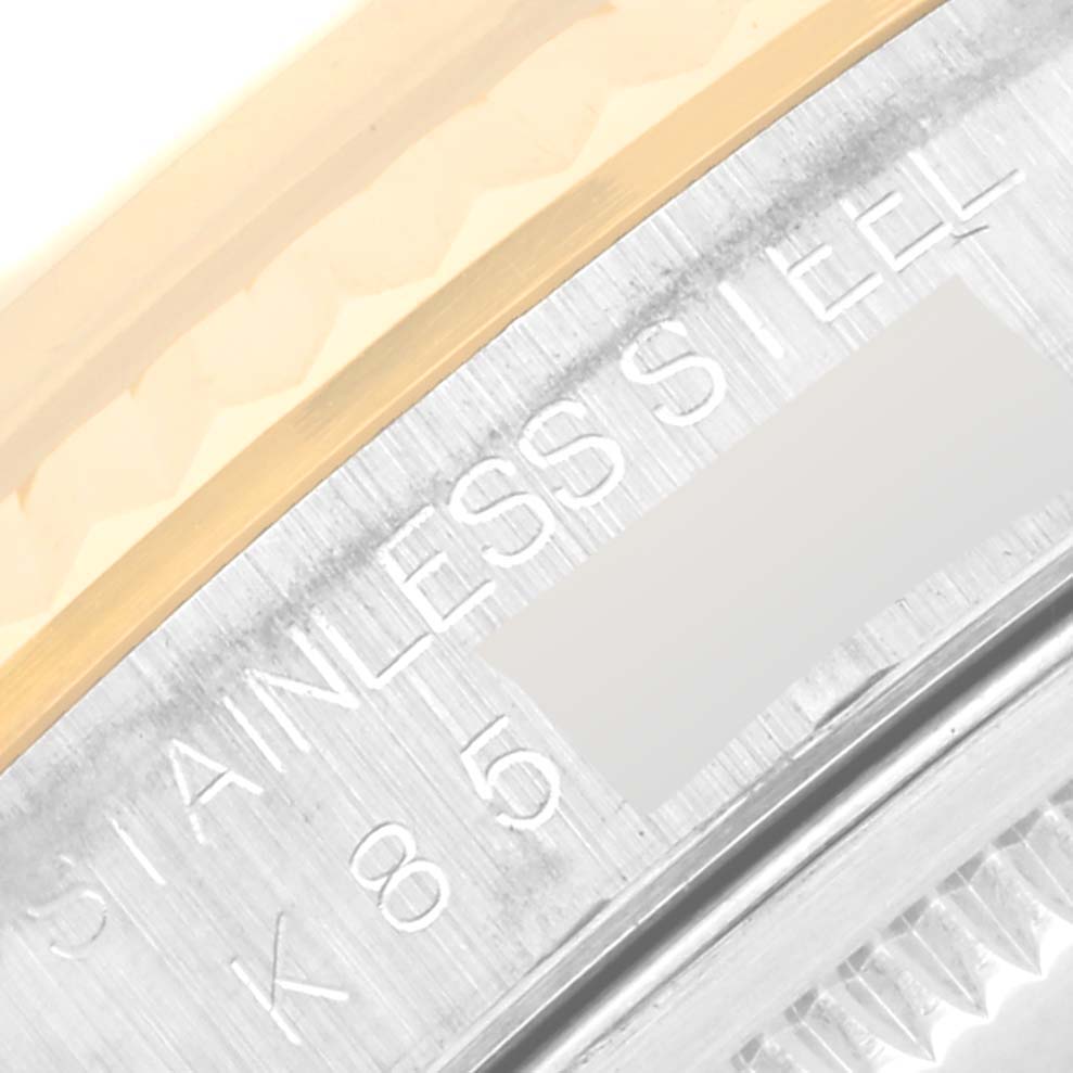 The image shows a close-up of the engraved side of the Rolex Datejust 16233 Men's Steel and Gold (two tone) Black Dial 16233 Men's Steel and Gold (two tone) Black Dial's stainless steel case.