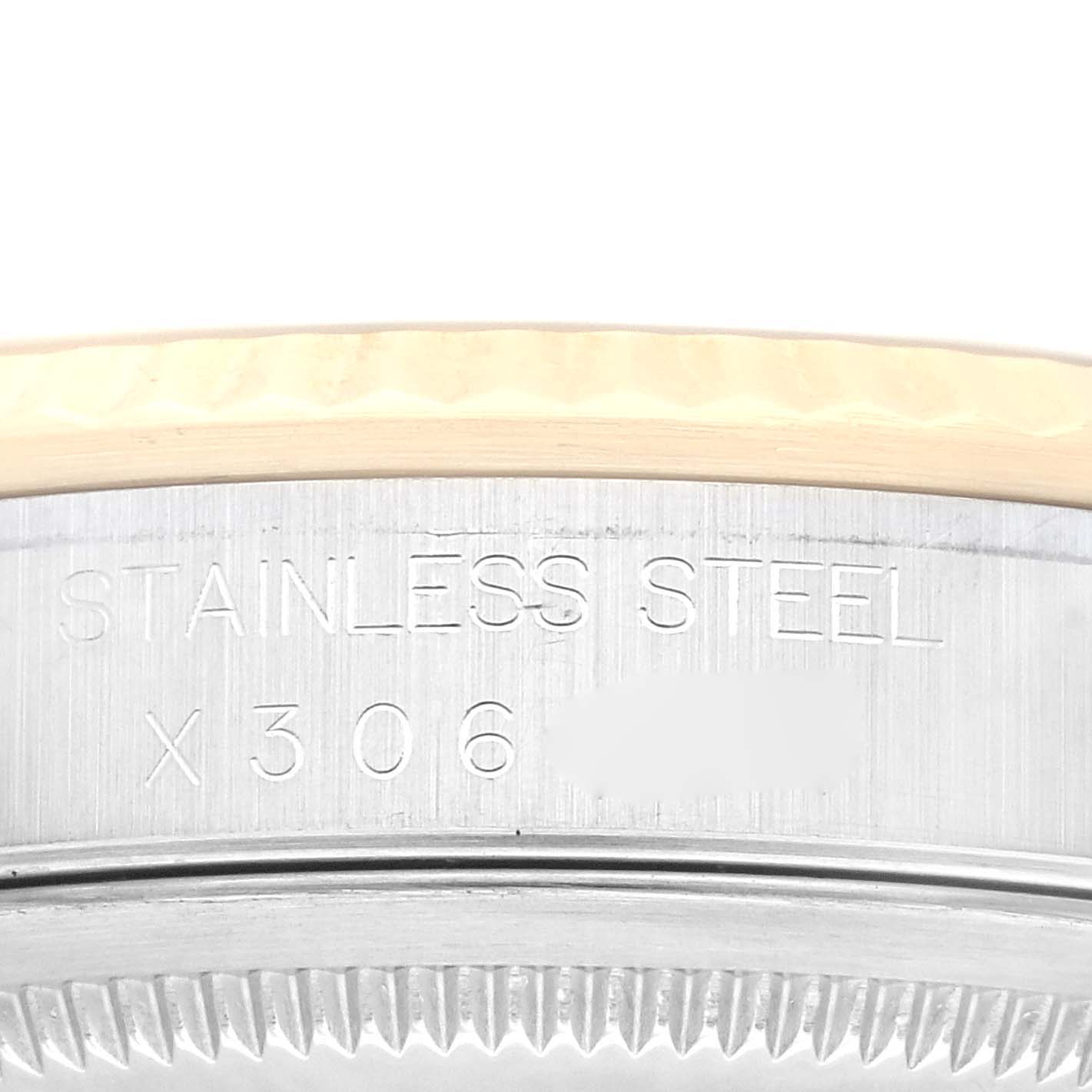 This image shows a close-up of the engraved serial number area and the bezel of a Rolex Datejust 16233 Men's Steel and Gold (two tone) Champagne Dial 16233 Men's Steel and Gold (two tone) Champagne Dial watch.