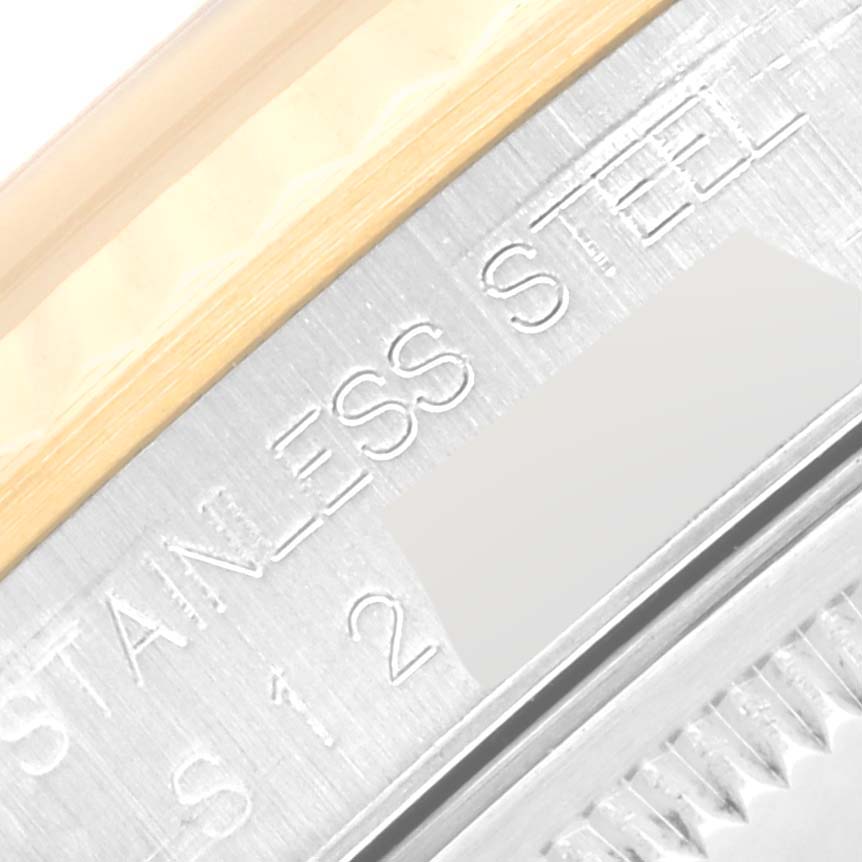 The image shows a close-up of the case side of a Rolex Datejust 16233 Men's Steel and Gold (two tone) Champagne Dial 16233 Men's Steel and Gold (two tone) Champagne Dial watch, highlighting the "STAINLESS STEEL" engraving.