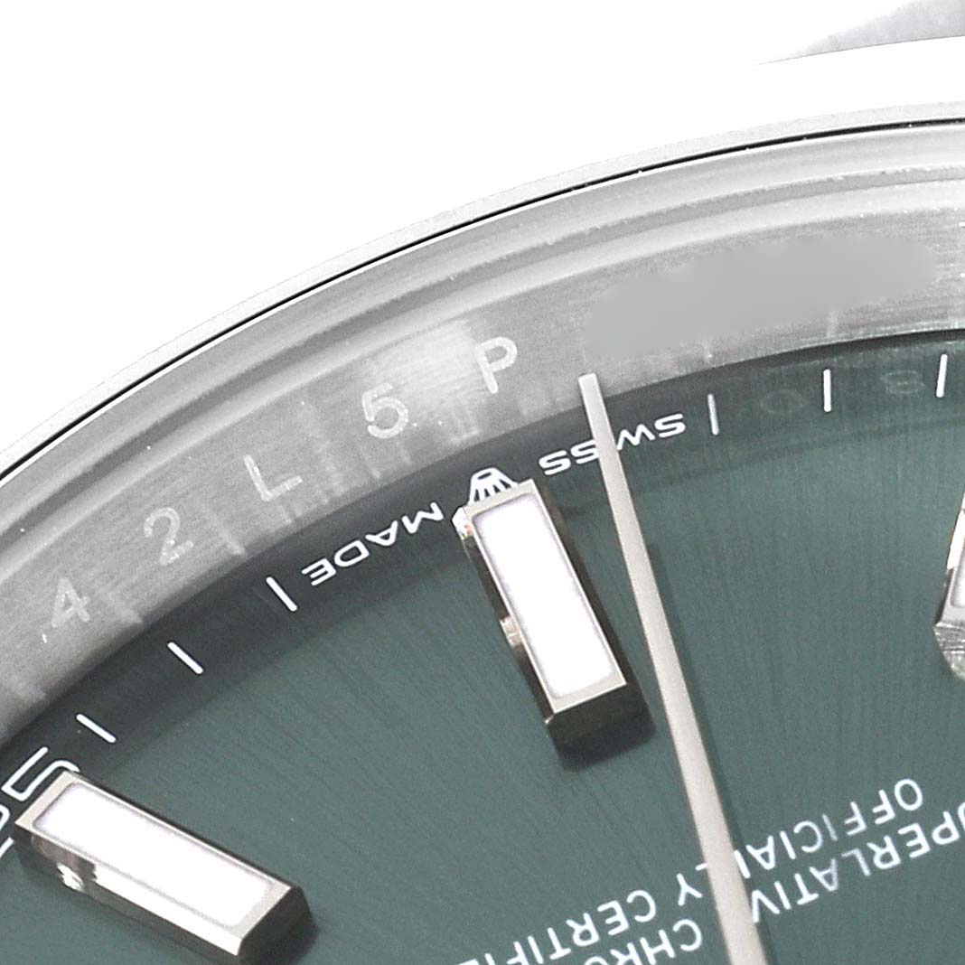 The image shows a close-up of the dial of a Rolex Datejust 41 126300 Men's Stainless Steel Green Dial 126300 Men's Stainless Steel Green Dial, highlighting the hour markers, minute indicators, and hands.