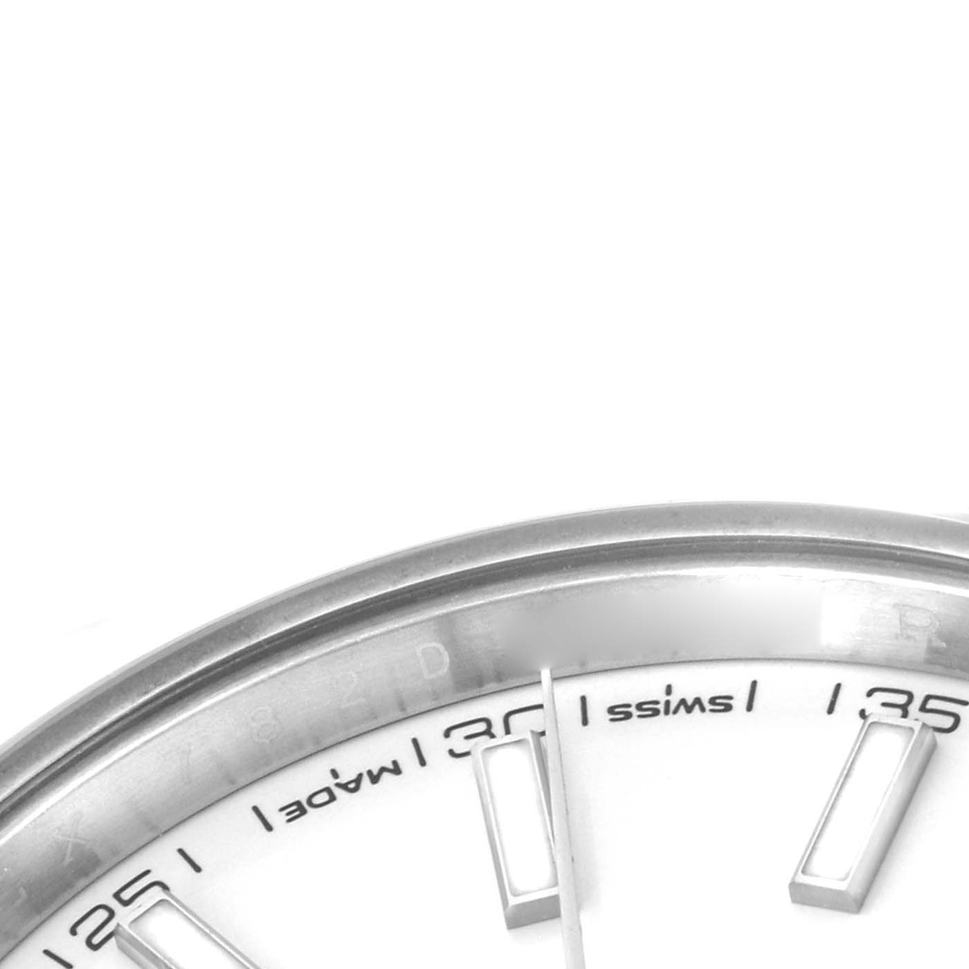 The image shows a close-up of the dial edge and bezel of the Rolex Datejust 41 126300 Men's Stainless Steel White Dial, highlighting part of the hour markers and minute details.