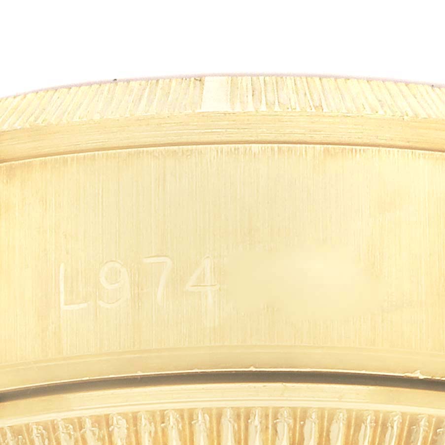 This close-up image shows the side profile, serial number, and fluted bezel of a Rolex President 69278 Women
s Yellow Gold Champagne Dial 69278 Women
s Yellow Gold Champagne Dial model watch.