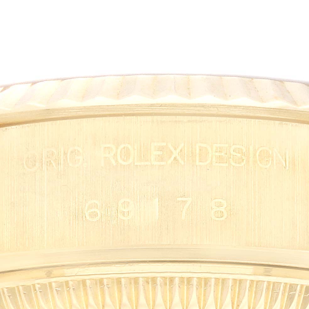 The image shows a close-up side view of the Rolex President 69178 Women
s Yellow Gold Champagne Dial 69178 Women
s Yellow Gold Champagne Dial watch, highlighting its engraved model number and branded inscription.
