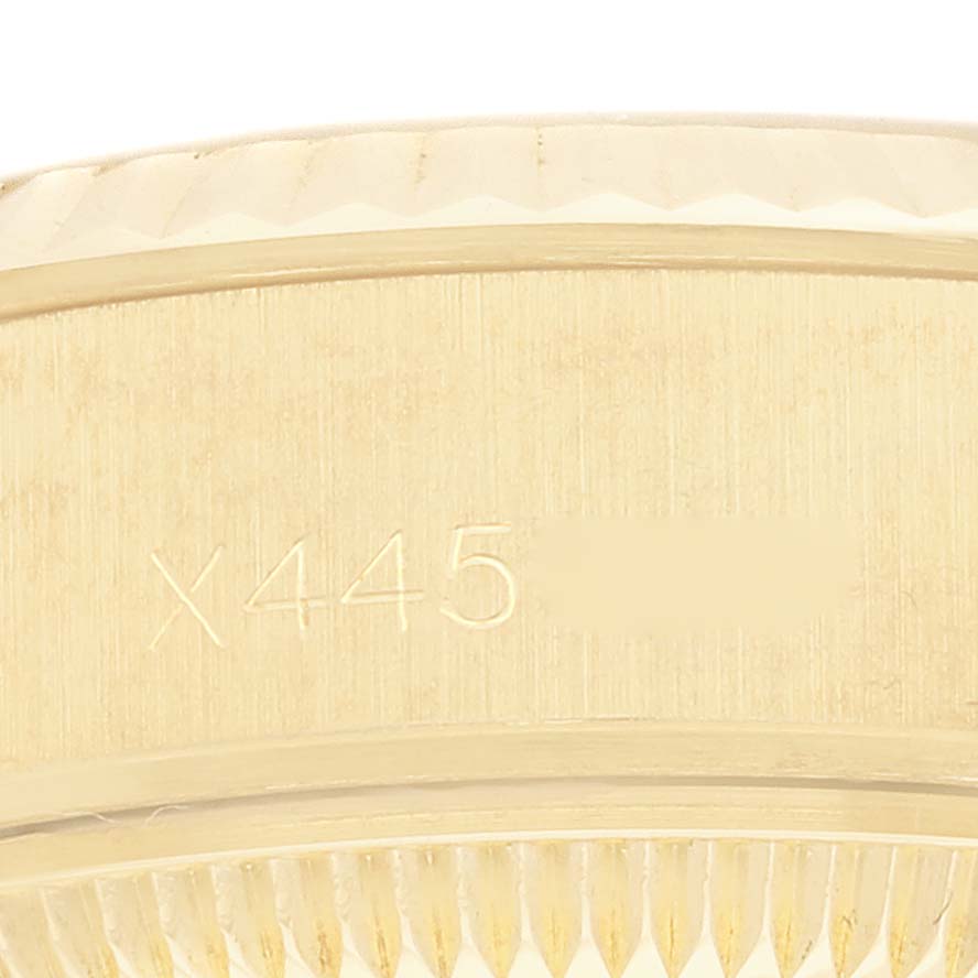 This image shows a close-up of the bezel and part of the casing on a Rolex President 69178 Women
s Yellow Gold Champagne Dial 69178 Women
s Yellow Gold Champagne Dial model watch.