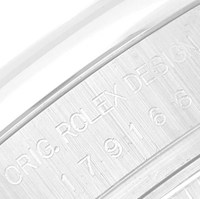 Close-up of the case back edge of a Rolex President 179166 Women's Platinum Silver Dial 179166 Women's Platinum Silver Dial model, showing engraved text and part of the watch's serial number.