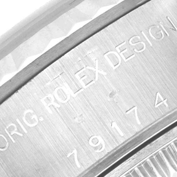 This image shows the engraved text on the case back of a Rolex Datejust 79174 Women's Stainless Steel Pink Dial 79174 Women's Stainless Steel Pink Dial watch.